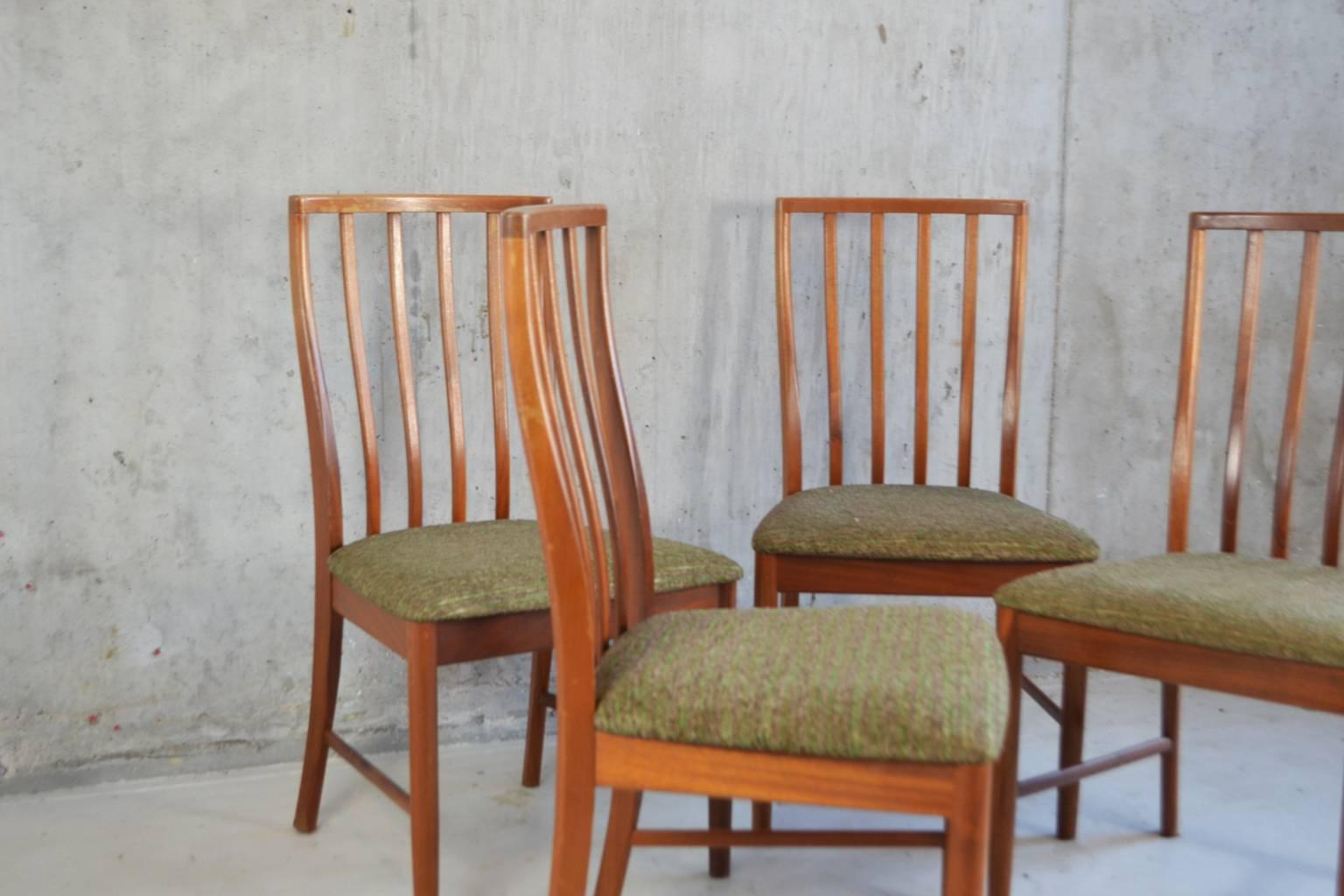 A fine set of four G-Plan high back dining chairs from the Fresco range, design by Leslie Dandy for G Plan. The chairs are incredibly comfortable and well made from solid teak with a shaped slatted back and upholstered seat with its original