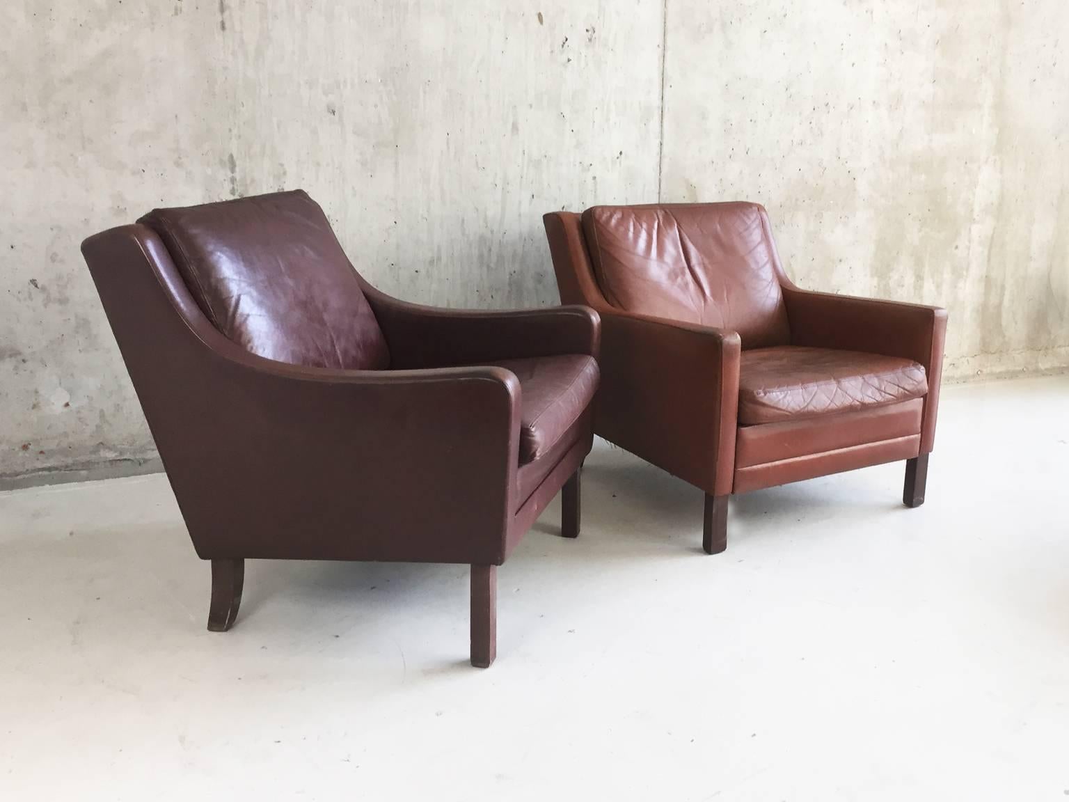 A great matching pair of elegant original 1970s Danish club or lounge chairs each upholstered in a different brown leather. Very much in the style of influential Danish furniture designer Børge Mogensen.

Designer: In the style of Børge