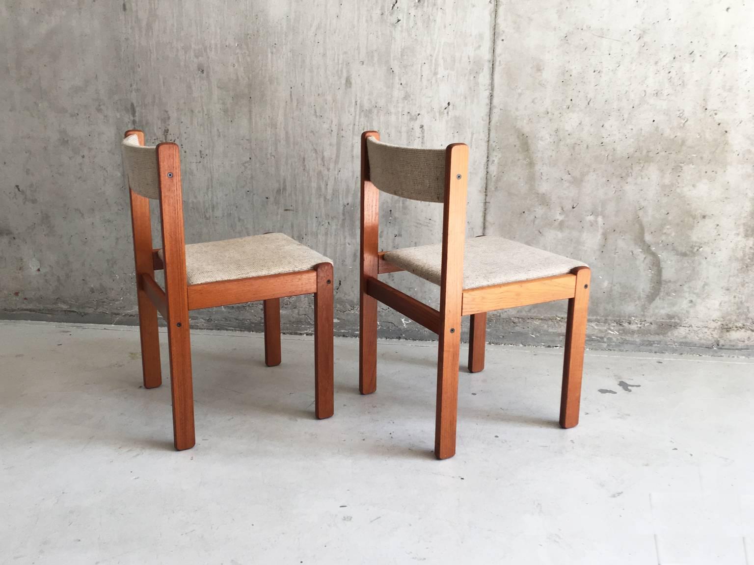 A superb pair of solid teak dining chairs by Christian Findahl. Highlighted by exposed finger joint construction and beautiful wool upholstery.
  