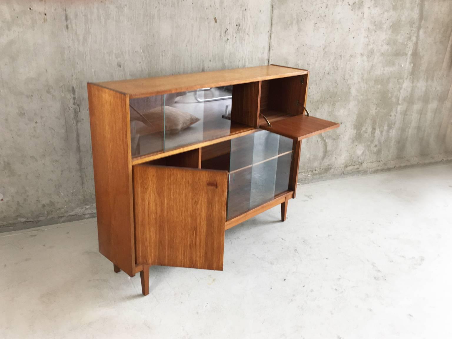 A lovely piece from English maker Nathan. Cool, restrained and well made with a mix of cupboards and bookshelves with glass doors.