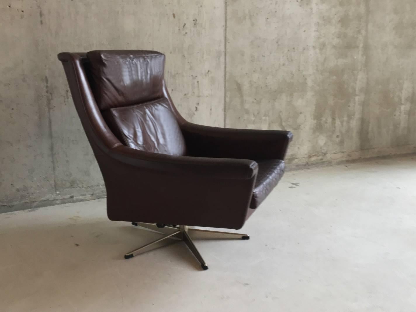 Superb shape. A lovely comfortable reclining chair made in Denmark in the late 1960s-early 1970s, upholstered in the original leather. With chromed steel base.