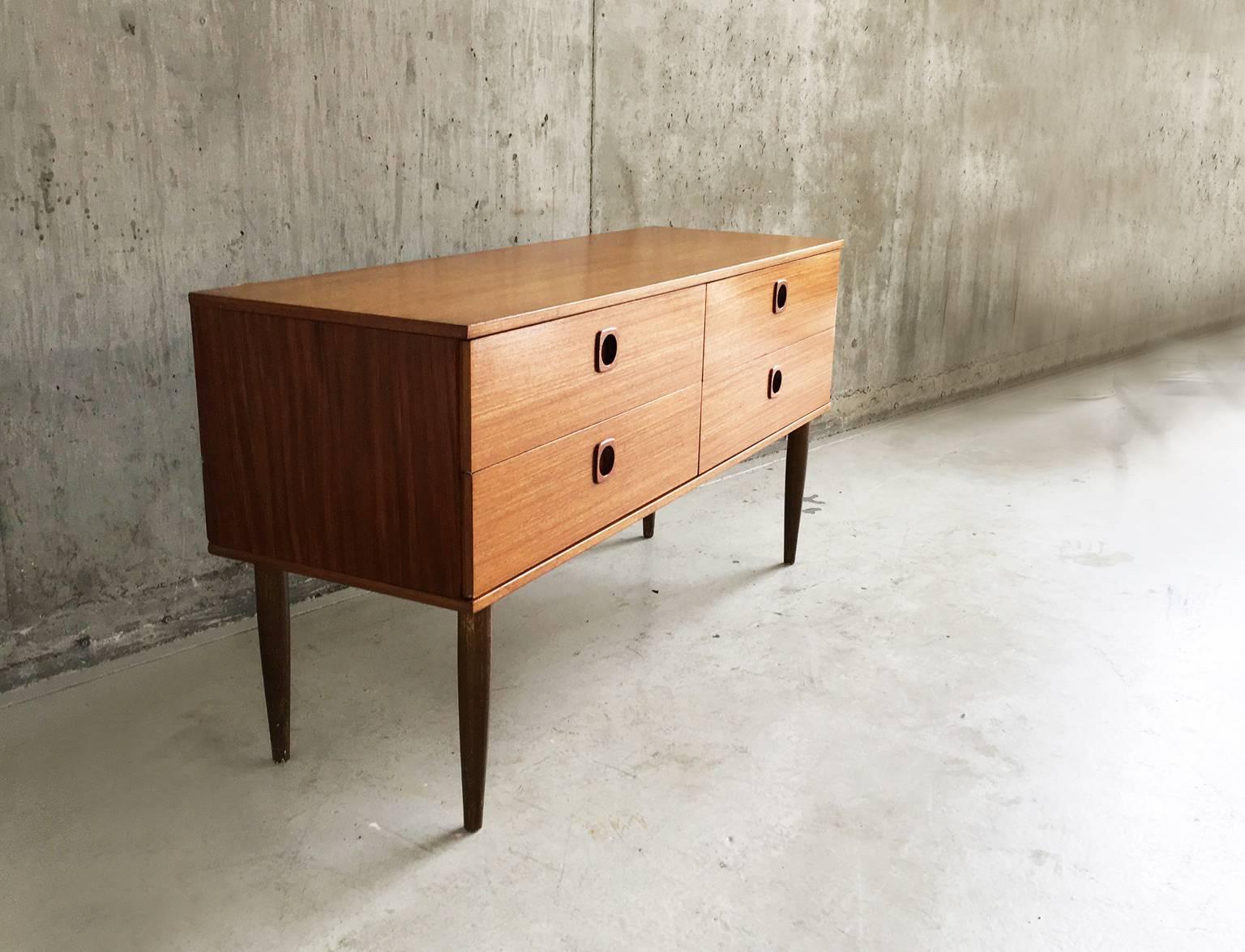 A very cute small chest of drawers made by British furniture company Schreiber. Nice drawer pull detailing and tall tapered feet.
 
 