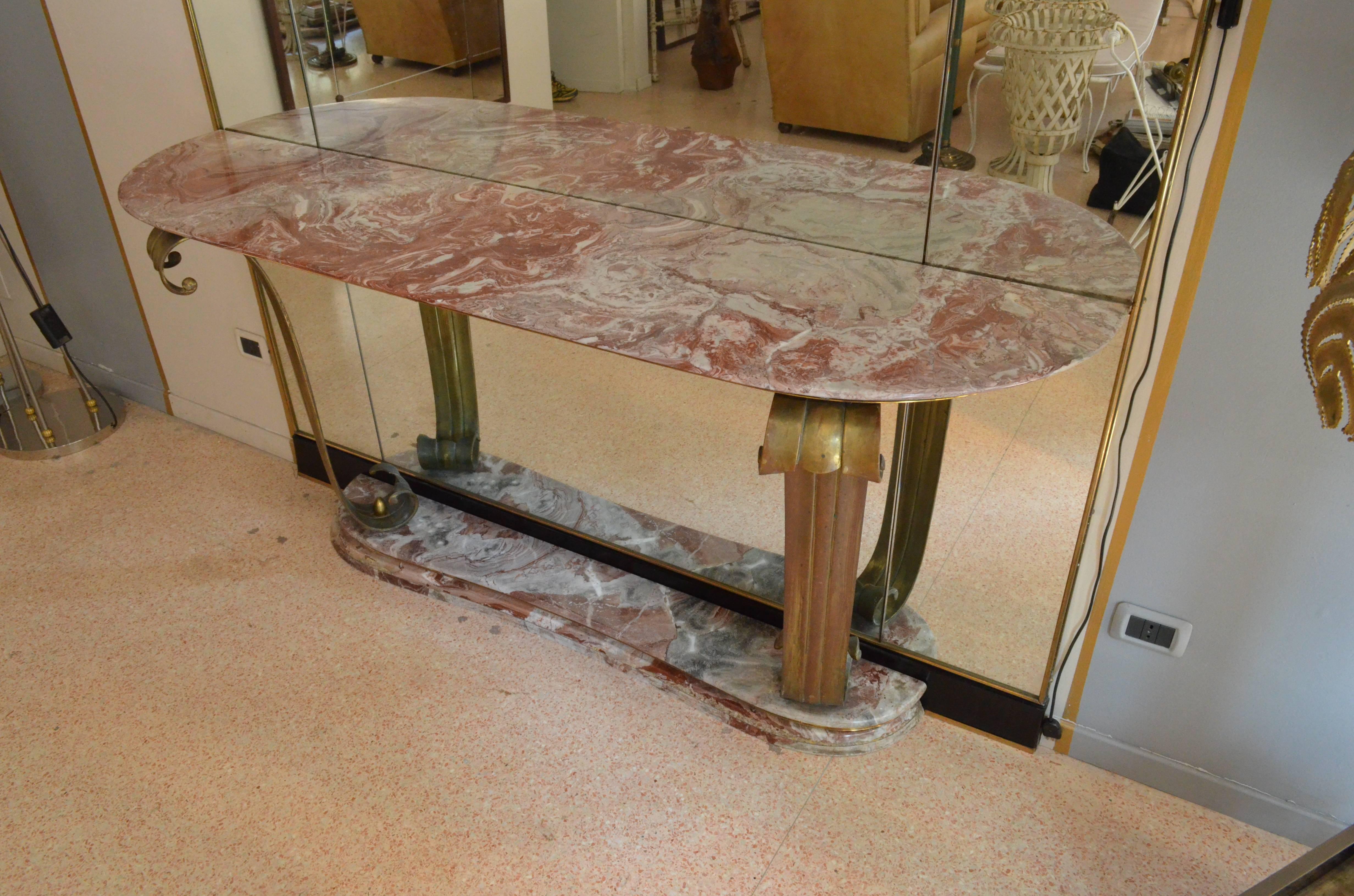 Rare and unique marble console, that comes with its own original big floor mirror to decorate an entire wall. The marble “Rosso Francia” is countered and it is in perfect conditions. The mirror is divided into different sections and at the higher