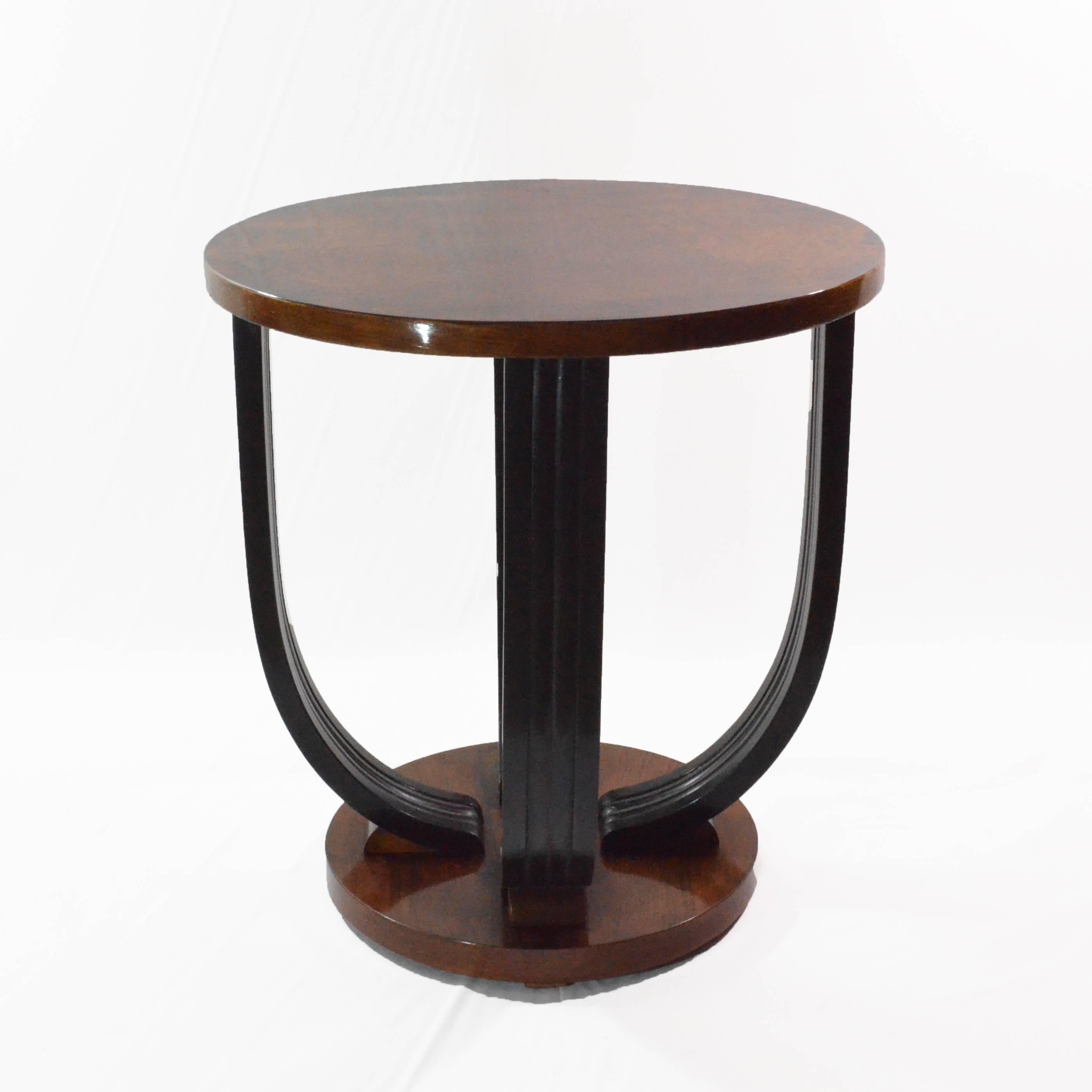 Small and ductile gueridon table from Art Deco period circa 1930 from France. It features two tiers, one of them is veneered and black ebonized legs with line and shape typical for the period. This gueridon suits not only living room as a sofa table