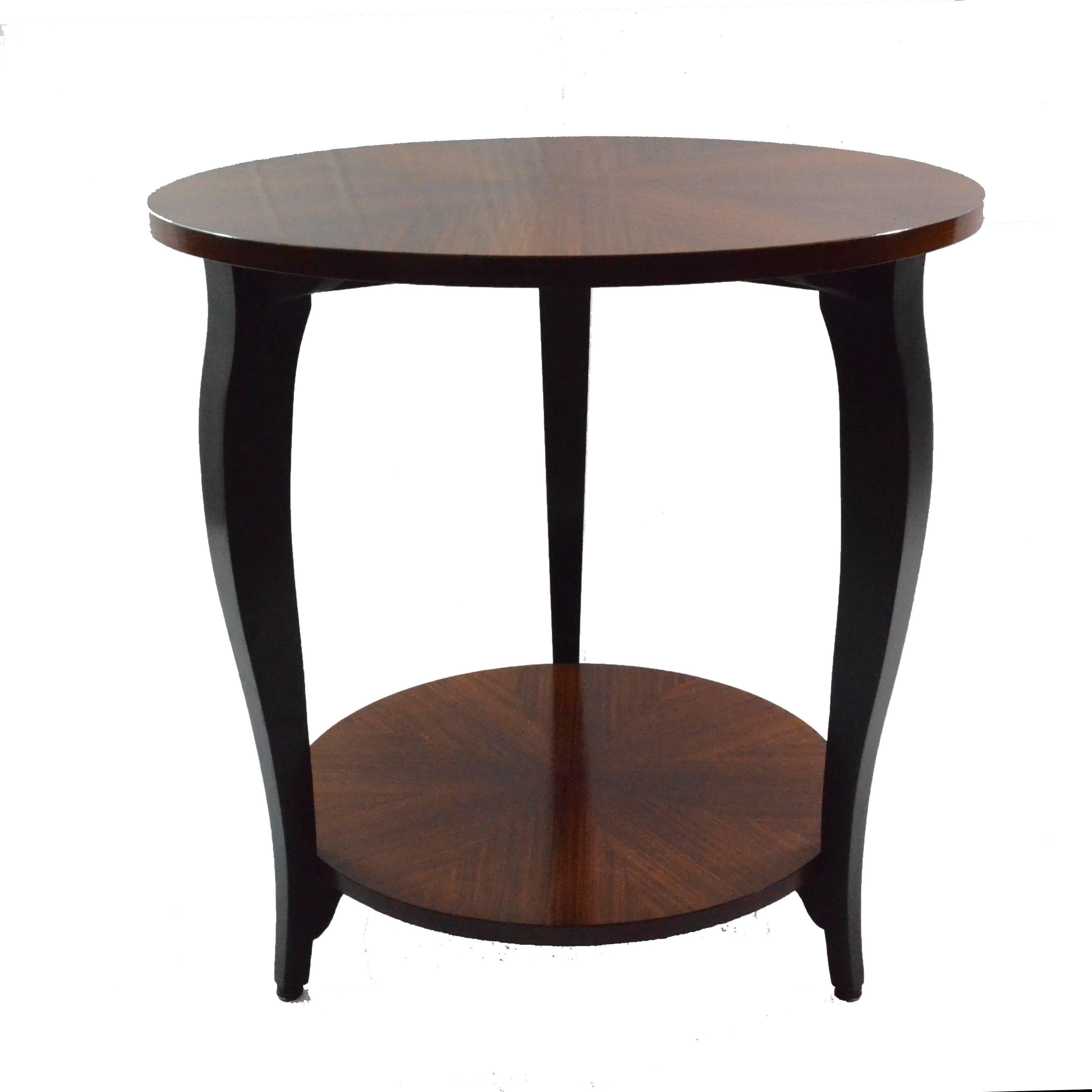 Small and ductile gueridon table from Art Deco period, circa 1930 from France. It features two tiers and three black ebonized legs with line and shape typical for the period. This Gueridon suits not only living room as a sofa table or bedroom as