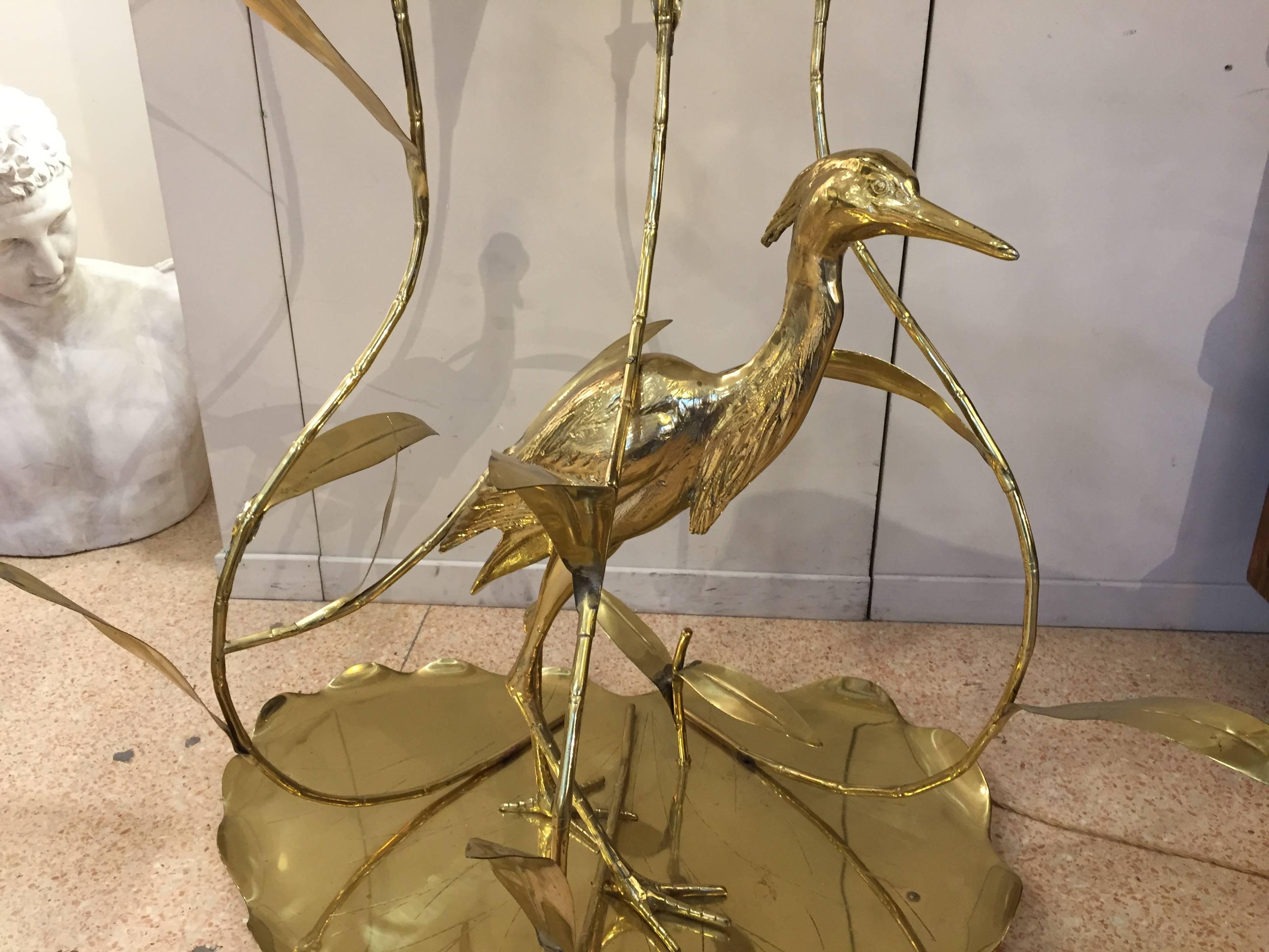 Floor lamp entirely made out of brass designed by Alfredo Freda, an important Italian designer in 1960s. Three lights with original blown glass lampshade. This lamp represent a heron between some bamboo sprouts. The mark of the production company is