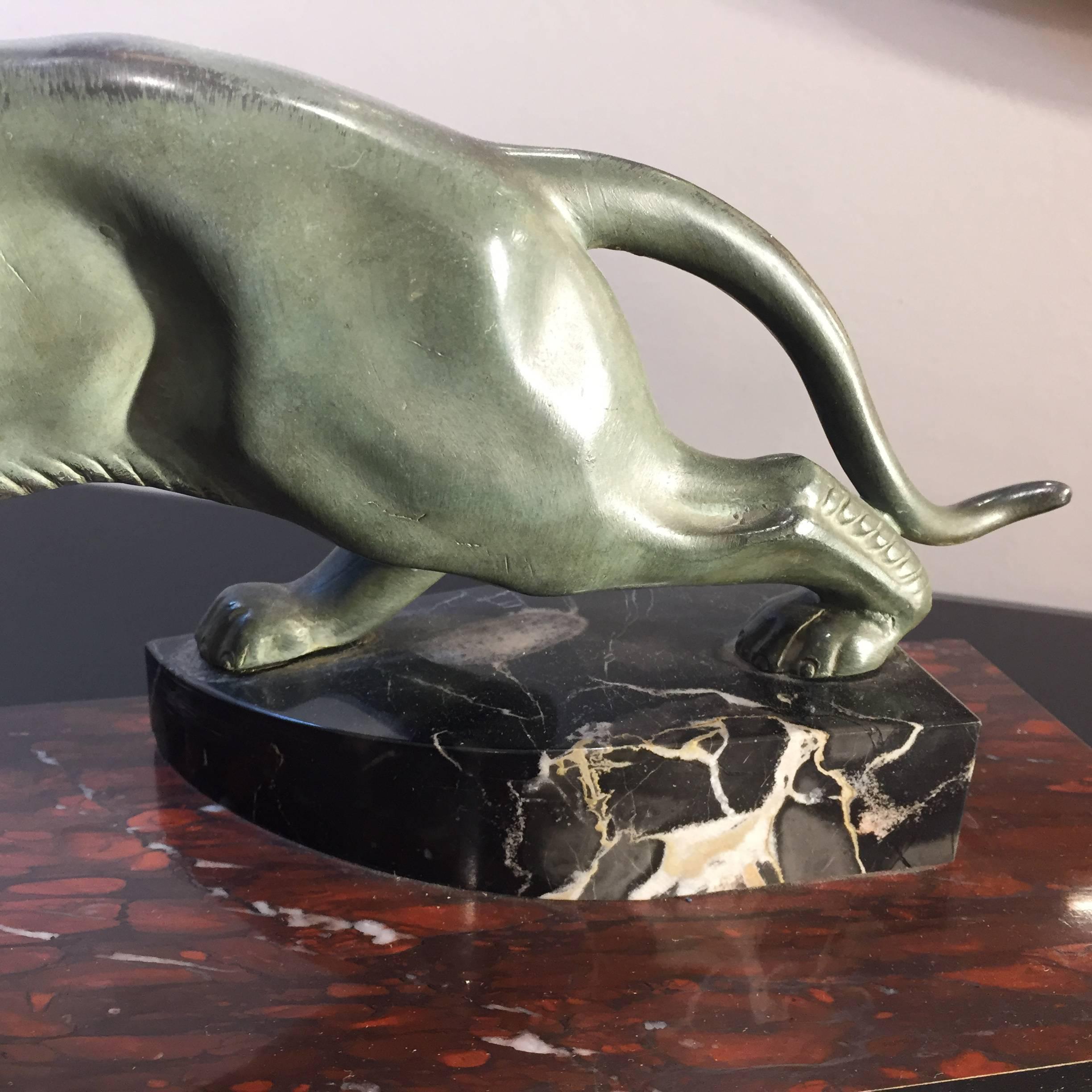 Small decorative panther made of out of a blend of metals (bronze and others) placed on a rich marble base composed by three kind of marble. This object is from Art Deco period from France. 
Its conditions are excellent no restoration needed. Small