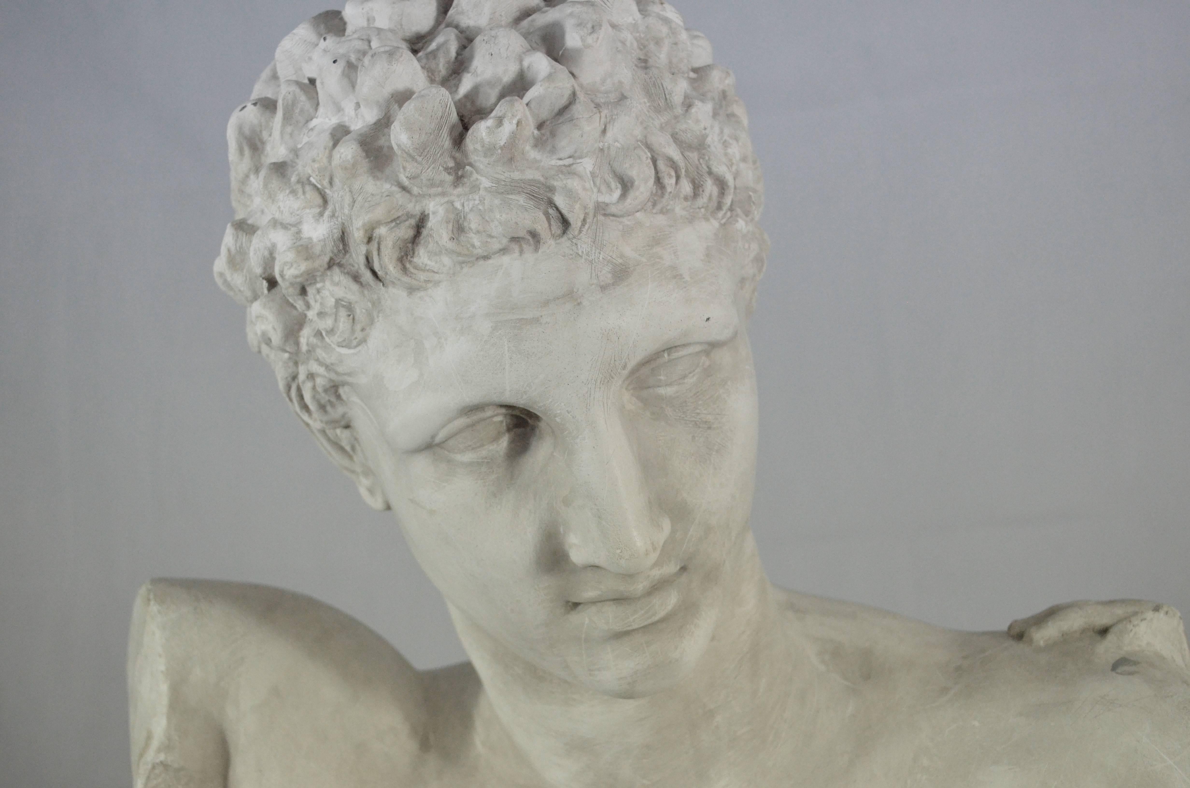 An academic bust representing Hermes from Parassitele, realized in  Italy, early 20th century. The original bust, how is stated in the tag on hte back is from the 340 B.C. and it is located in the Olimpia Museum (Greece).  The object is in perfect