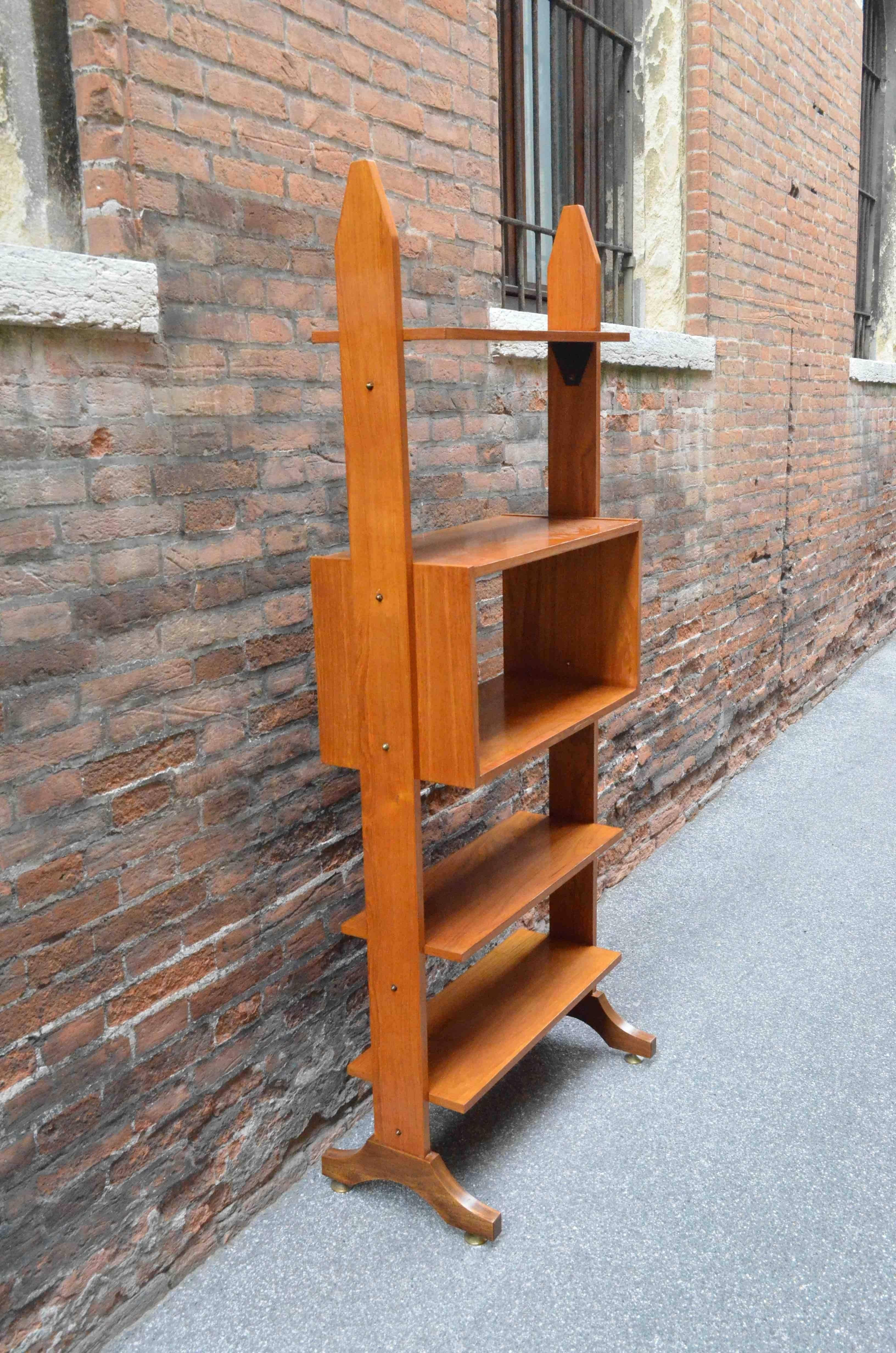 A linear cherrywood bookcase from Italy from late 20th century, 1970s. Brass feet. Suitable to be used to divide a room, perfect at the entrance.
size: h 200 cm, w 80 cm, d 42 cm.
A video of the object is available upon request. To have a fast and