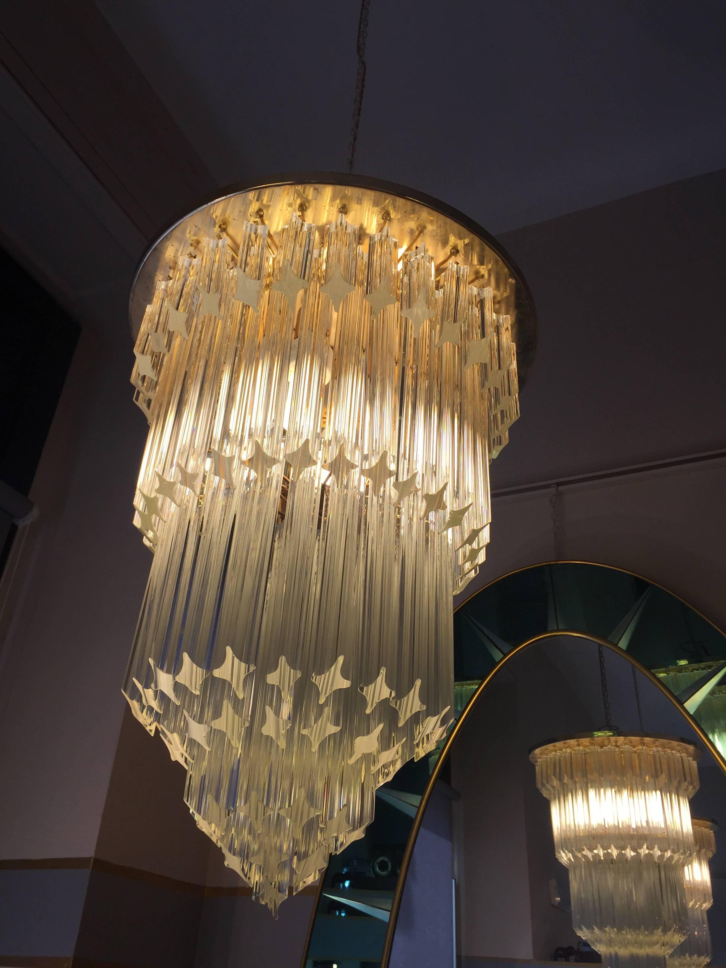 Chandeliers made in Italy during 1960s. Composed by massive glass pieces and a brass disc in the upper part.

They have four lights each. They have been rewired, cleaned and restored in a conservative way.

They are completely dismountable.

To have