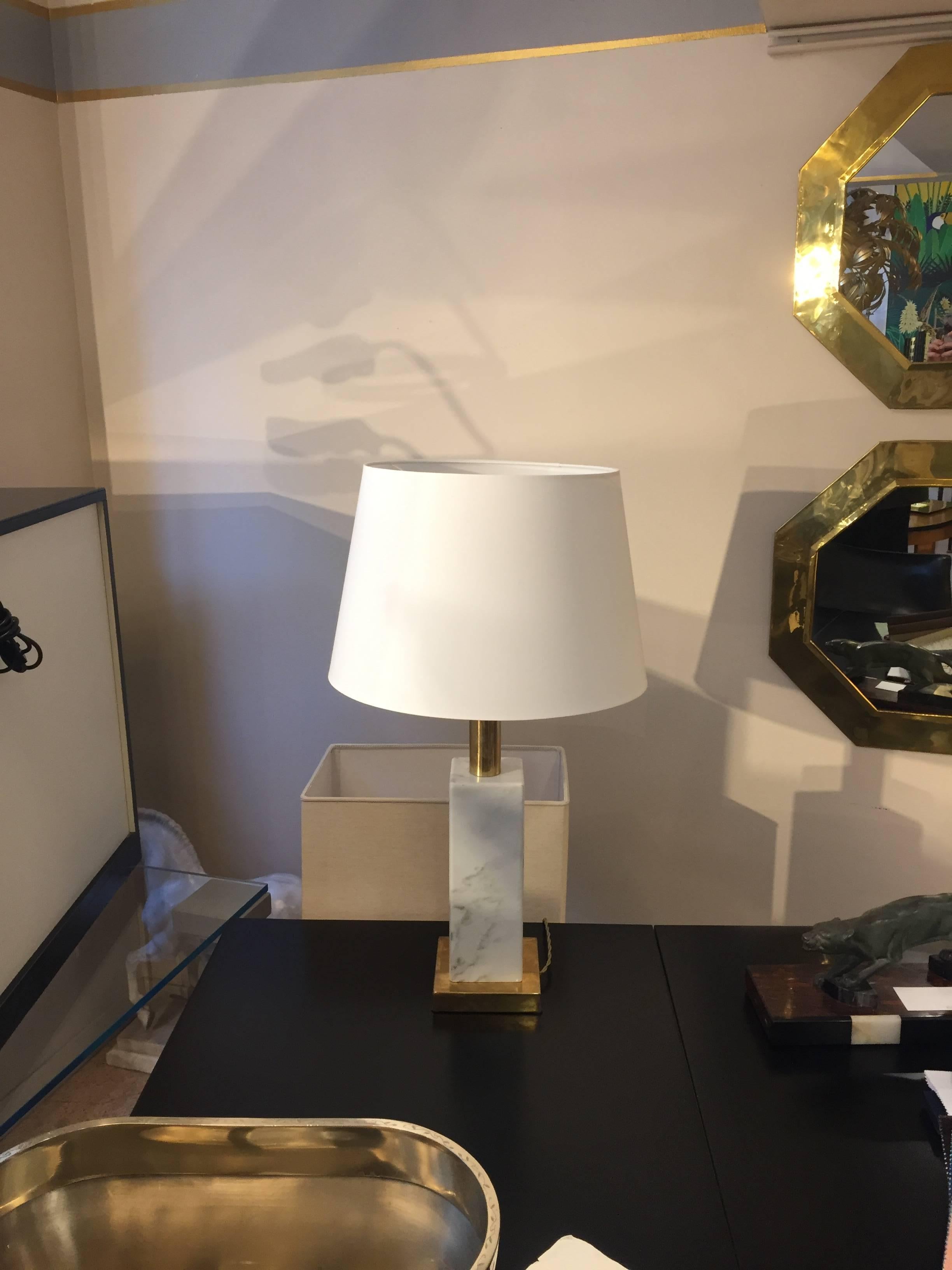 1960s table lamps from Italy. White Carrara marble squared base with golden brass details. Recent but customizable white rounded lampshade. These table lamps are very solid ones since the marble is massive, further the brass detail confer these
