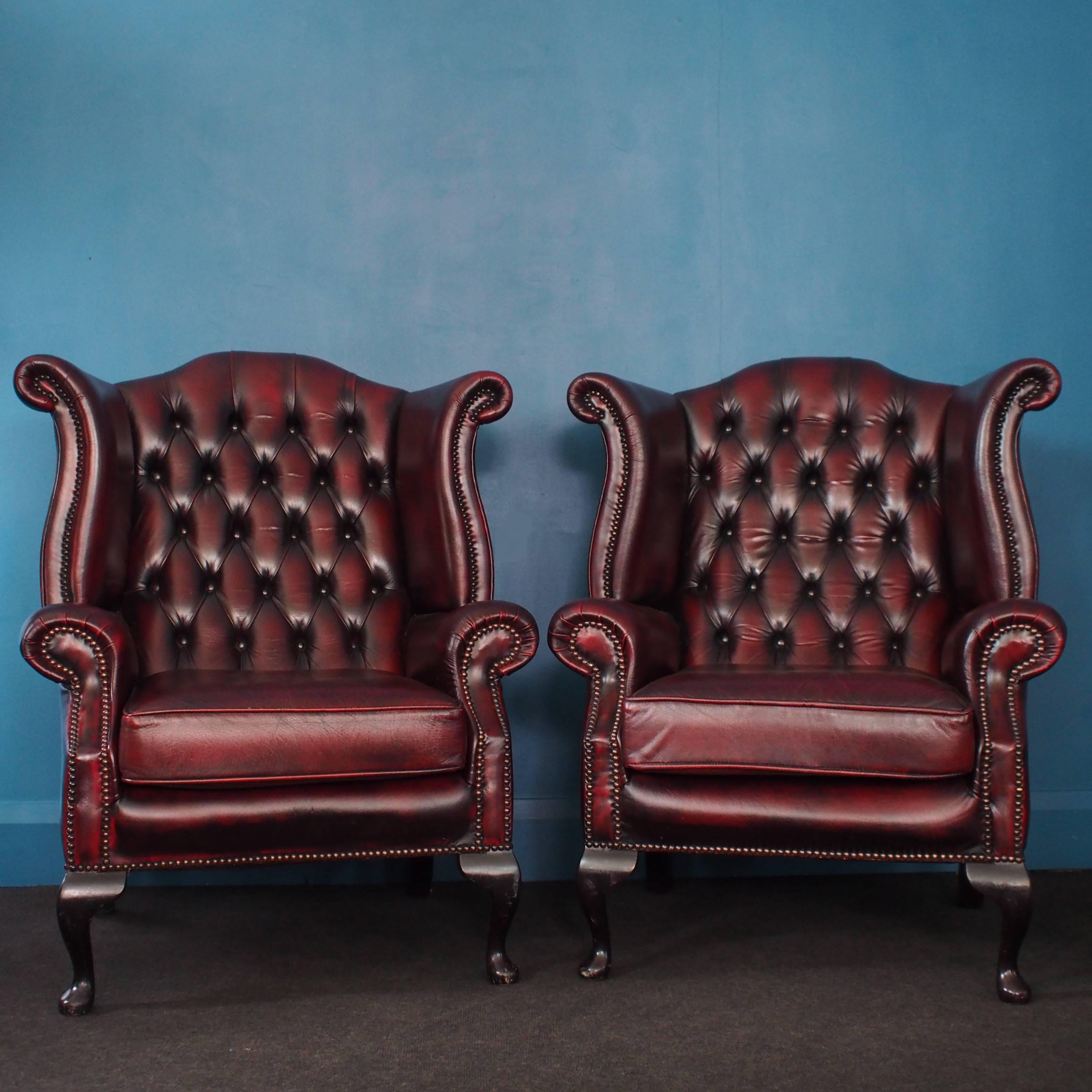 Upholstered in oxblood leather, this pair of matching wingback Chesterfield armchairs have cabriole legs at the front and curved legs at the rear. The seat cushions are removable.

*Free UK shipping (*postcode dependent) is offered for these