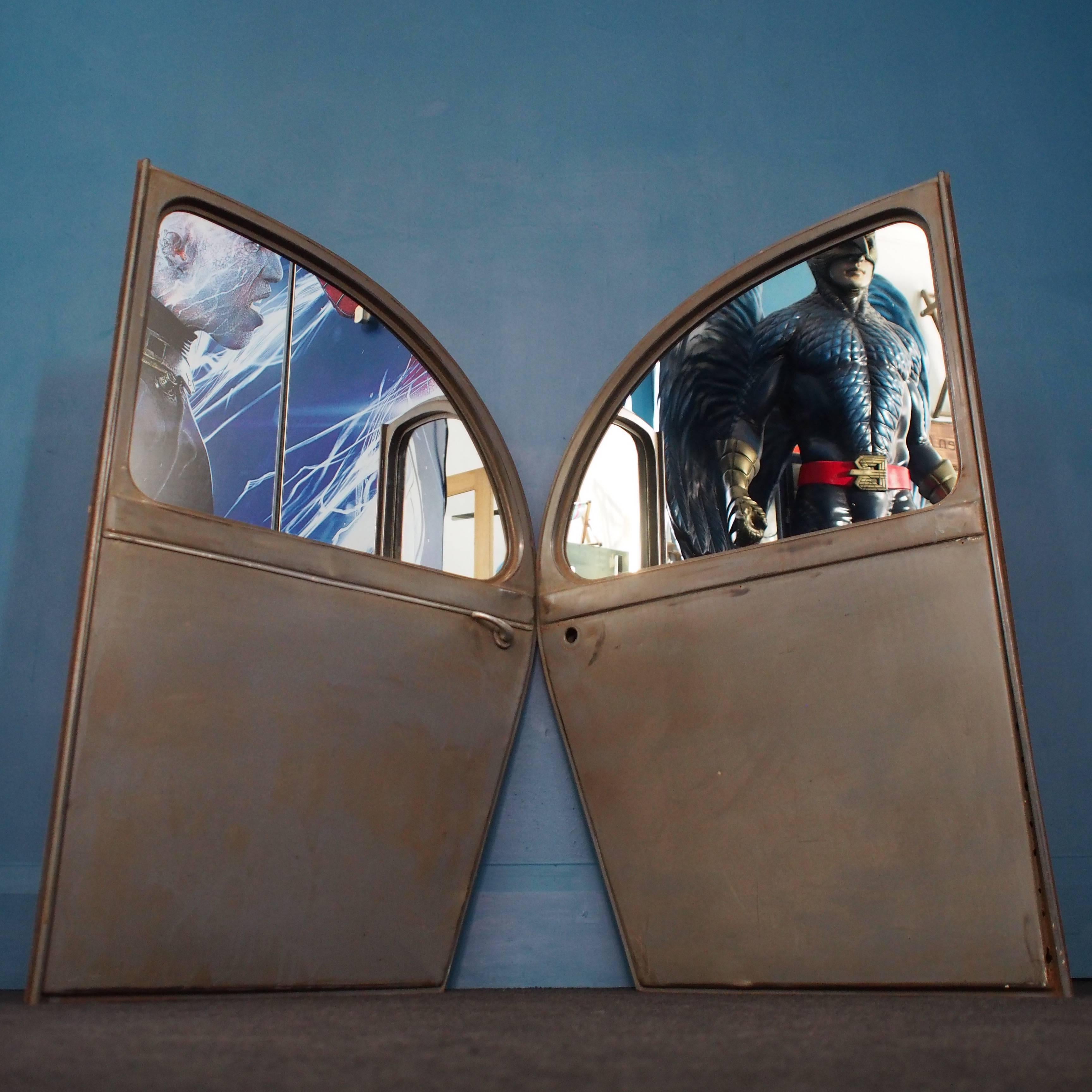 A pair of vintage French 2CV rear doors dating back to the 1940s have been creatively and sympathetically transformed into quirky industrial vintage mirrors. The doors retain their original outer French Grey paintwork and have some surface marks and