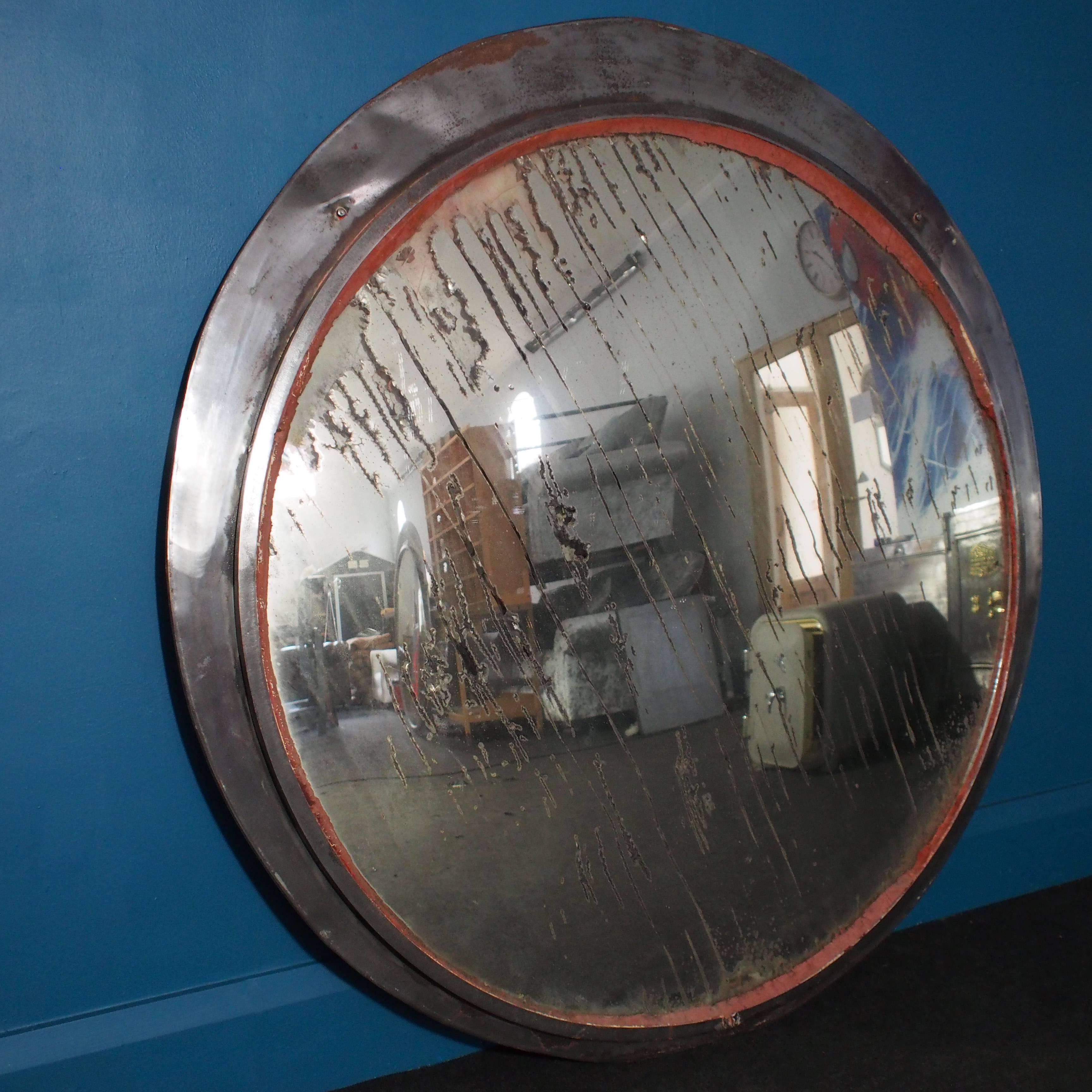 With fabulous scrape-like ageing to the silvering on the rear of this mirror, caused by years and years of weathering, this large vintage convex mirror from the Czech Republic is a truly unique piece. The circular convex mirror is set slightly