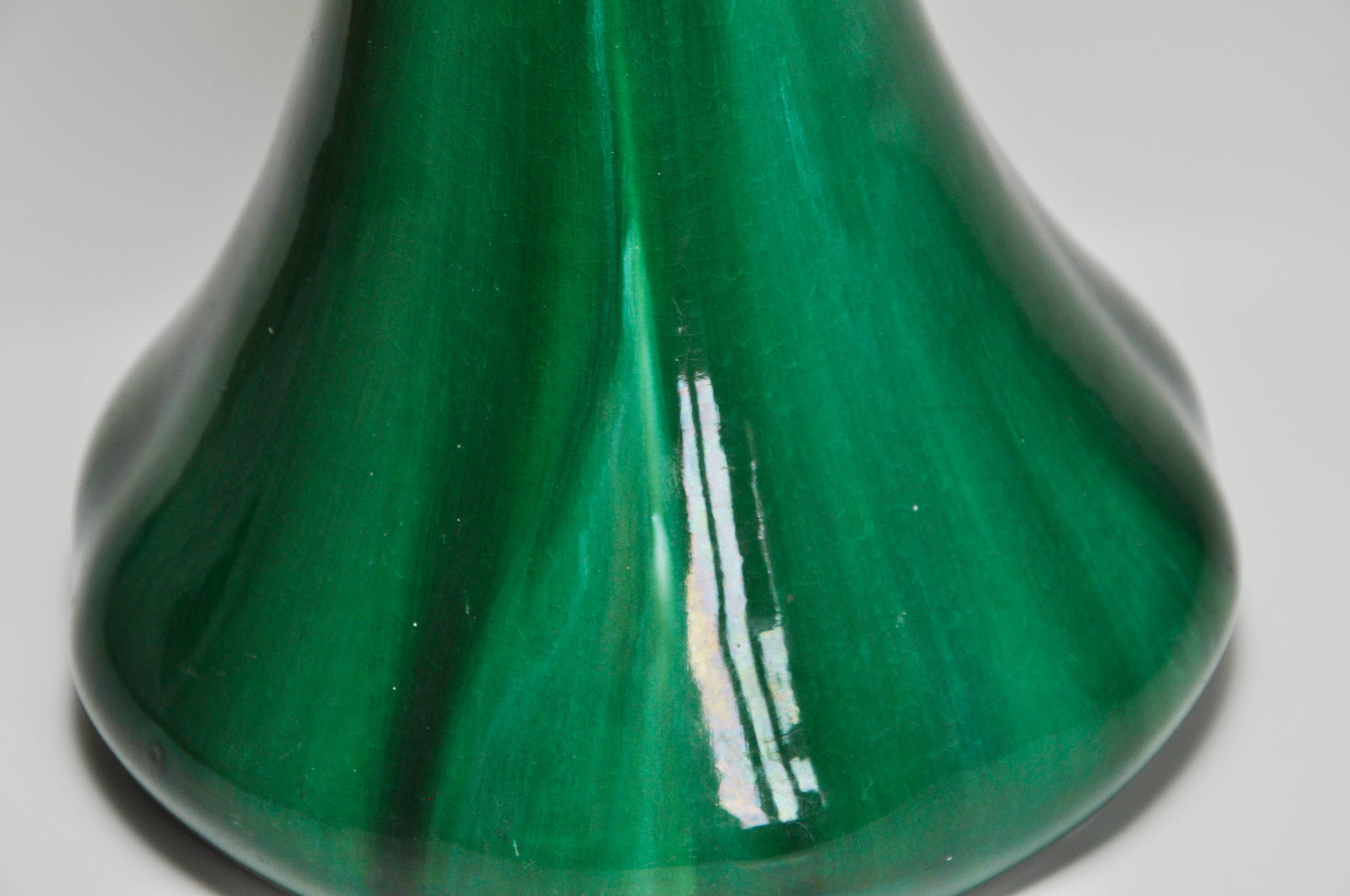 A beautiful piece of English art pottery with a glossy jade green glaze with elegant lines flowing down the tall neck into a voluptuous base. Japonist in shape and rather bulbous in form like a tulip with delicate rounded bulges both top and bottom.