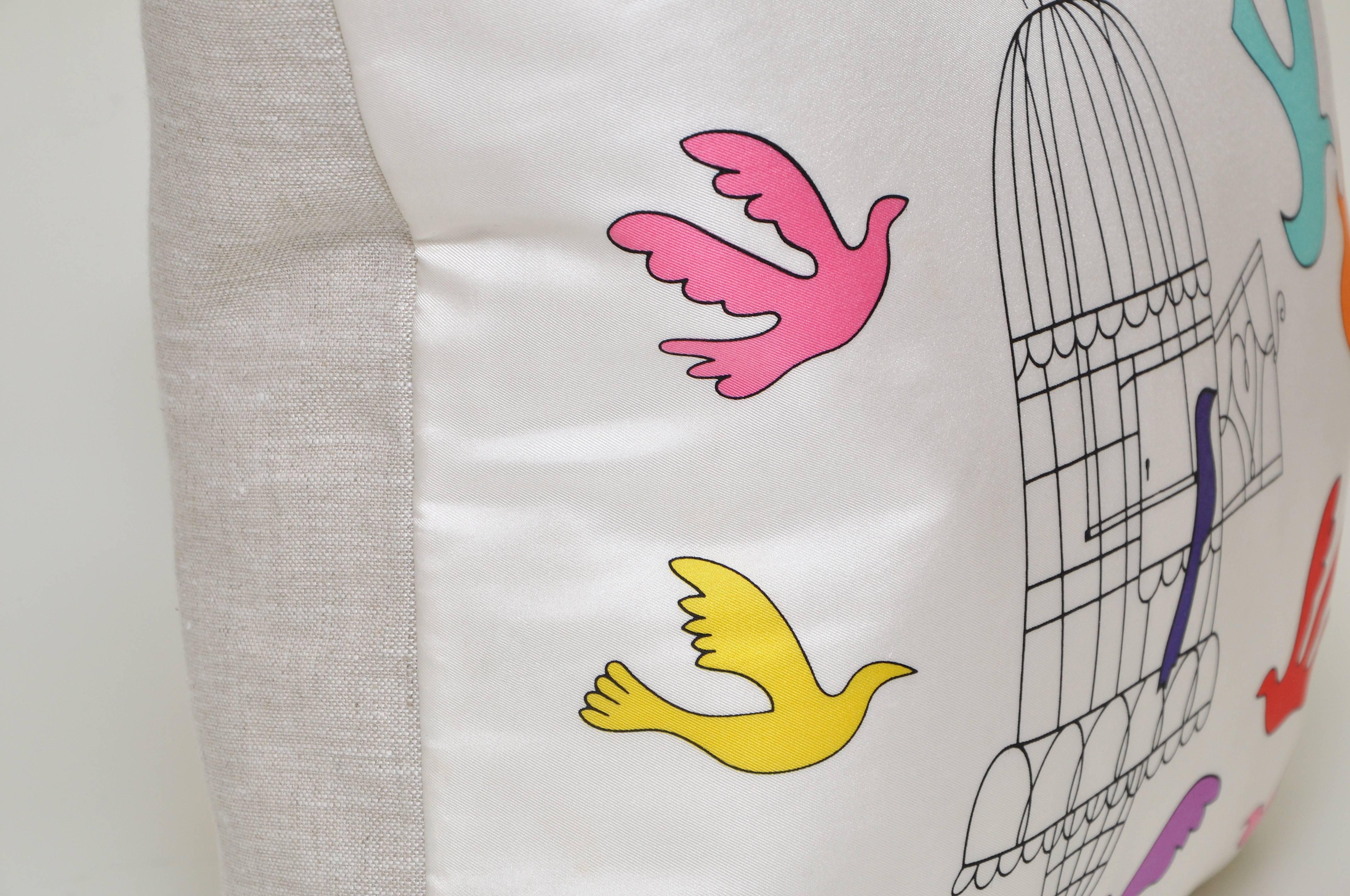 Custom-made one-of-a-kind luxury cushion created from a beautiful vintage silk Nina Ricci fashion scarf in an exquisite birdcage and flying birds design. A delightful picture illustrating a flock of multicolored stylised birds seemingly being