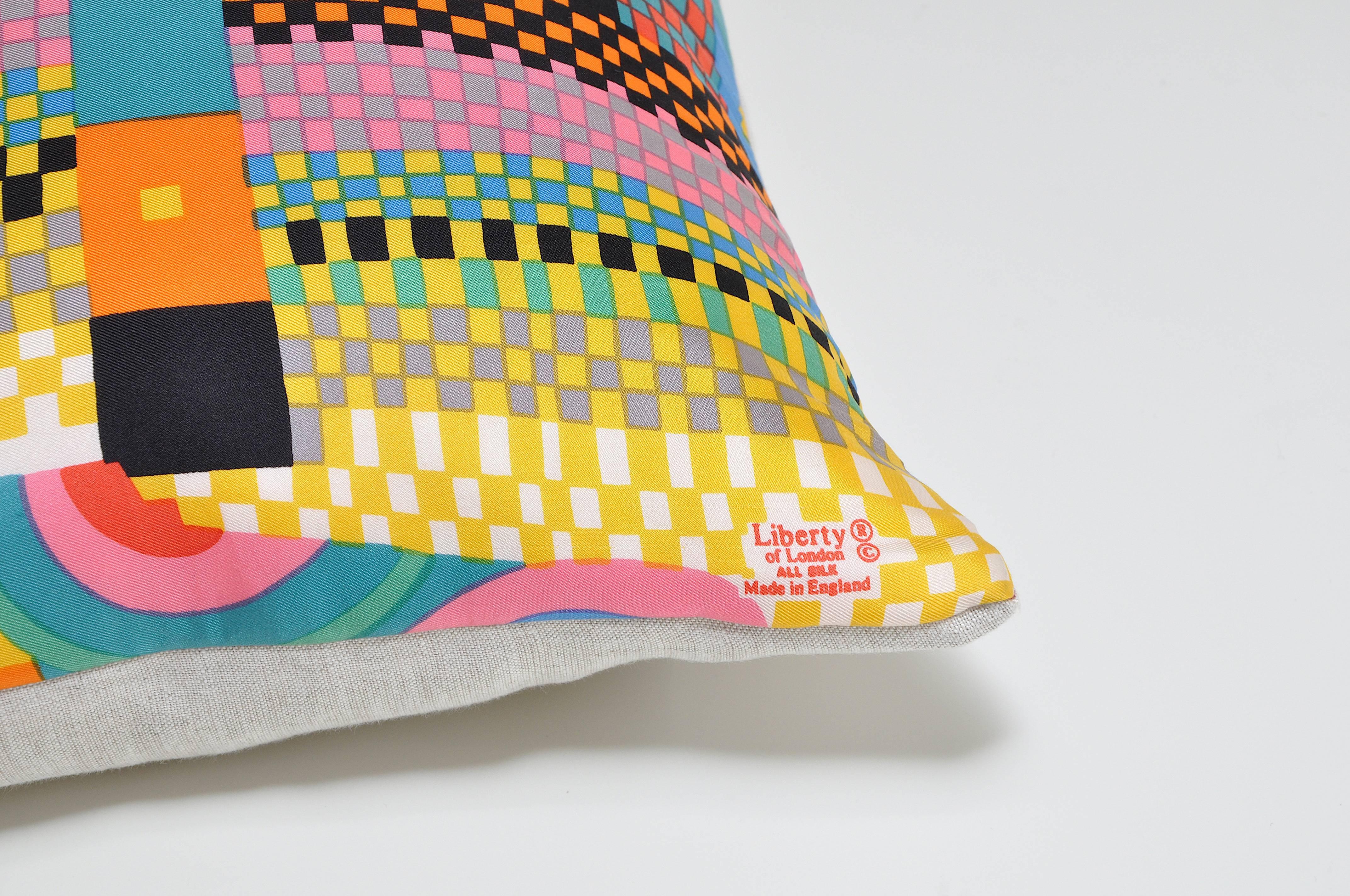 Custom-made one-of-a-kind cushion (pillow) created from an exquisite, circa late 1970s vintage silk Liberty of London fashion scarf in a bright multi-colored geometric pattern. Squares, stripes, chequered sections and wavy lines all make up an