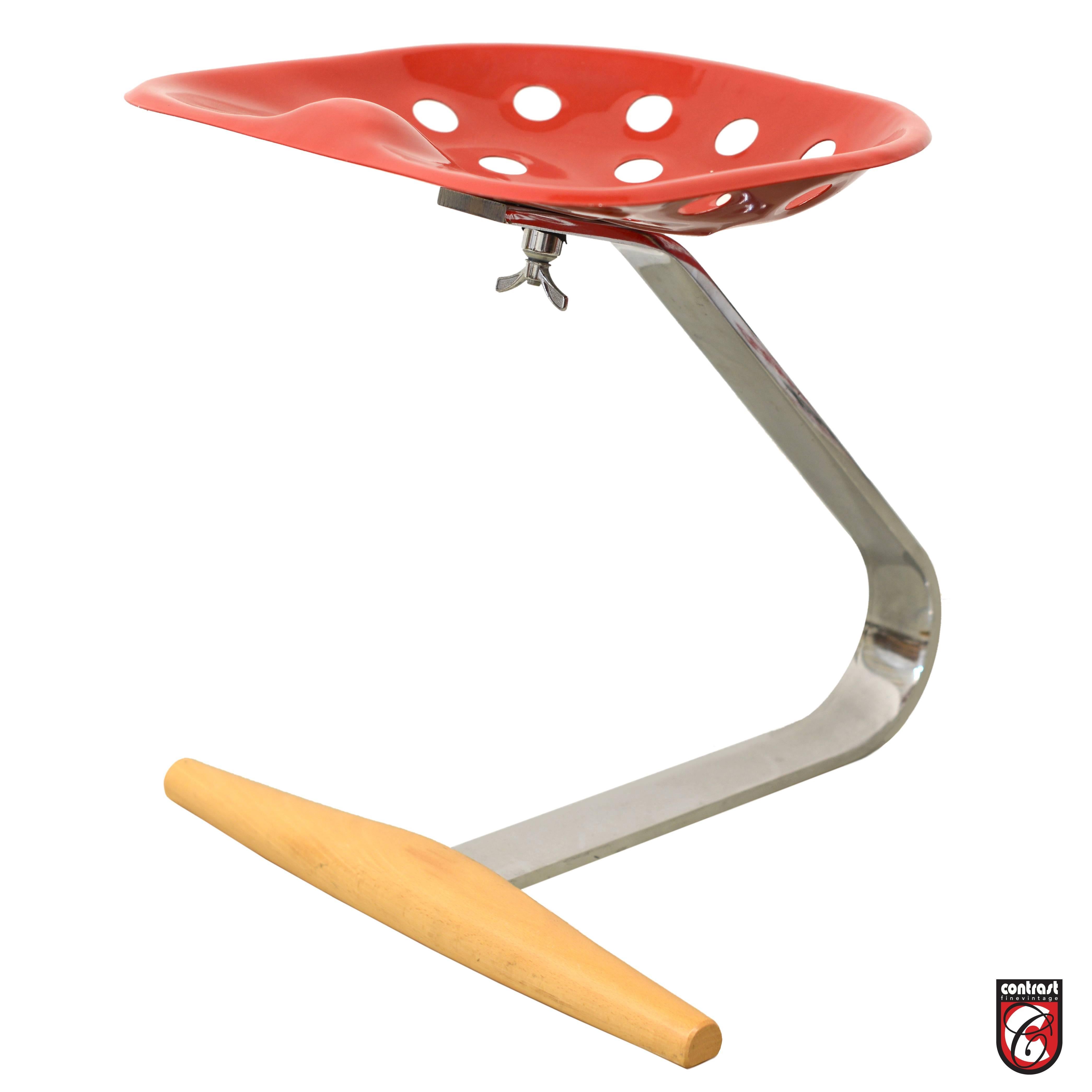 Designer: Achille Castiglioni for Zanotta, Italy. 
Sometimes known as the Tractor stool, the mezzadro was designed for the 1957. 
Triennial at Villa Olmo. It is made of four pieces: the seat, a large wing nut, a leaf
spring and a cross bar. The