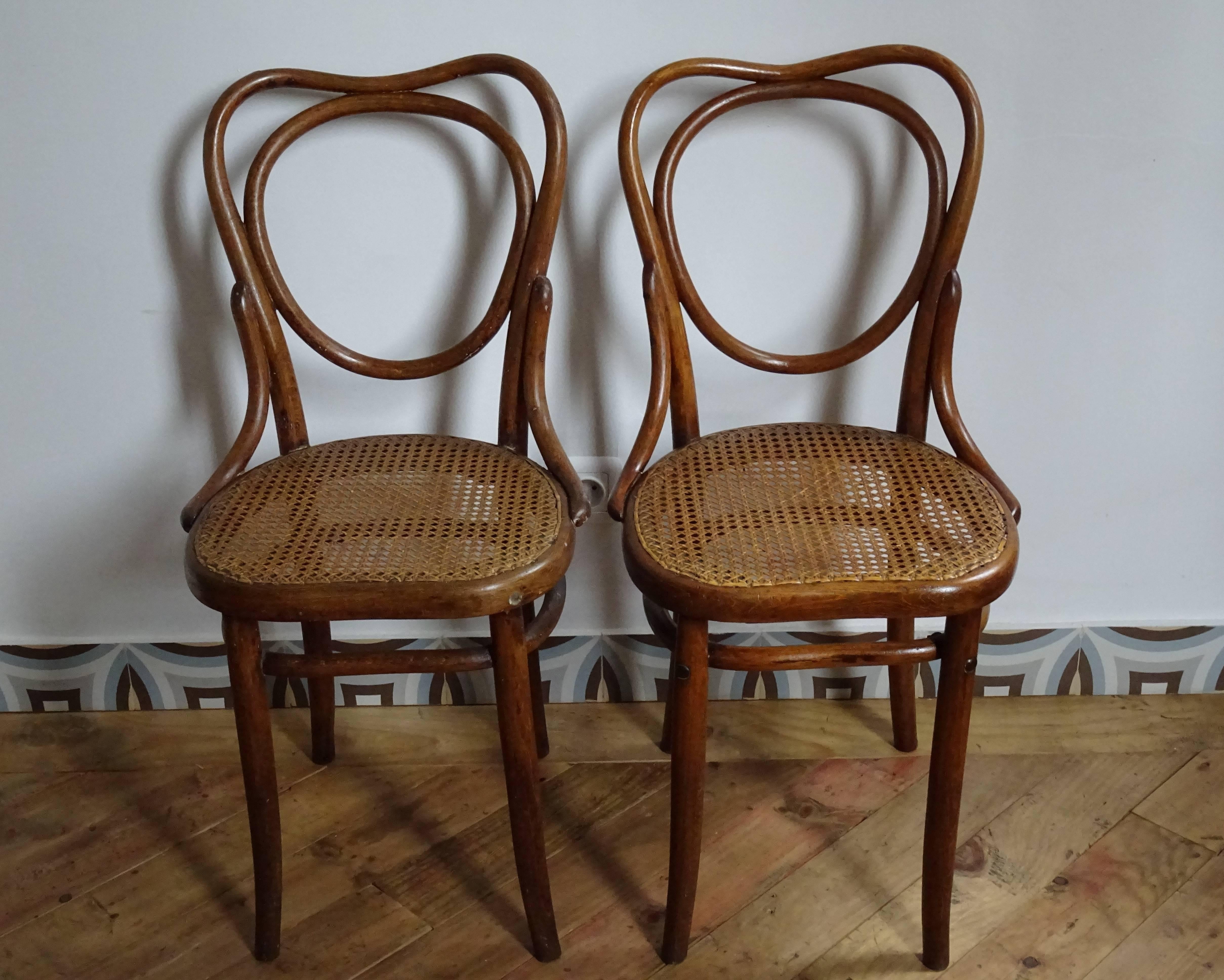 Set of two beechwood and cane French bistro chairs.