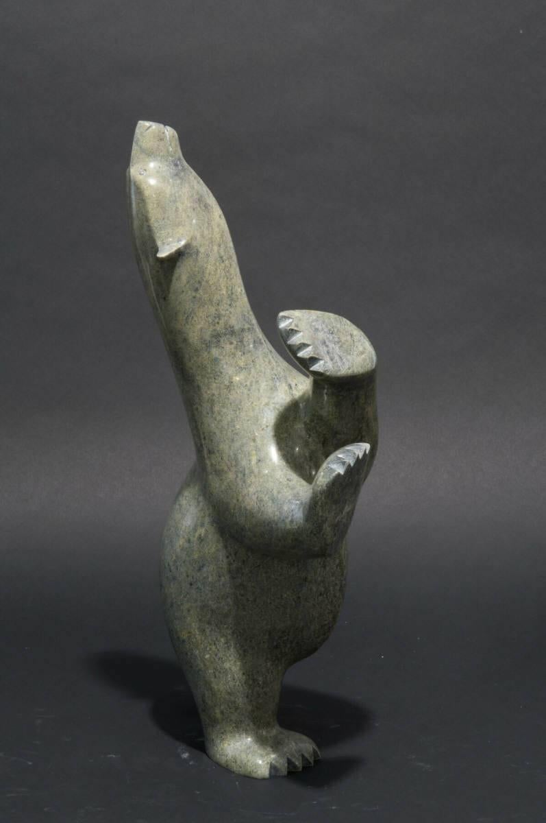 This wonderful Inuit serpentine stone sculpture of a dancing bear is by noted Cape Dorset artist Ashevak Adla. Ashevak Adla was born in 1977 and is well-known for his dynamic interpretations of arctic wildlife.