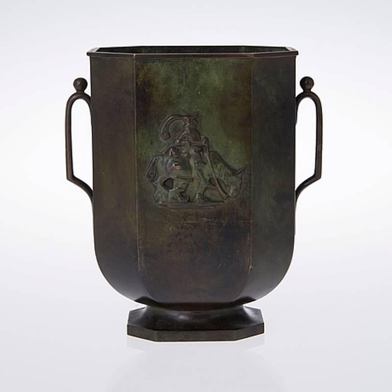 A pair of bronze vases by Just Andersen (1884-1943), for GAB (Guldsmedsaktiebolaget AB).
Each with a superb deep patina, of stylized urn shape, with a central relief depicting Don Quixote, on octagonal feet and flanked by handles topped with a