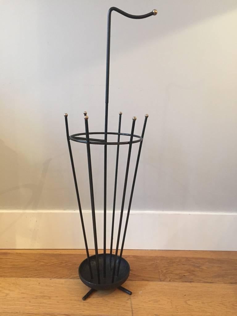 A black enameled iron and brass umbrella stand,
France, circa 1950.