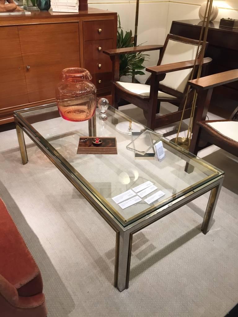 A brass and chrome glass topped coffee table, possibly by Romeo Rega.
Italy, circa 1970.