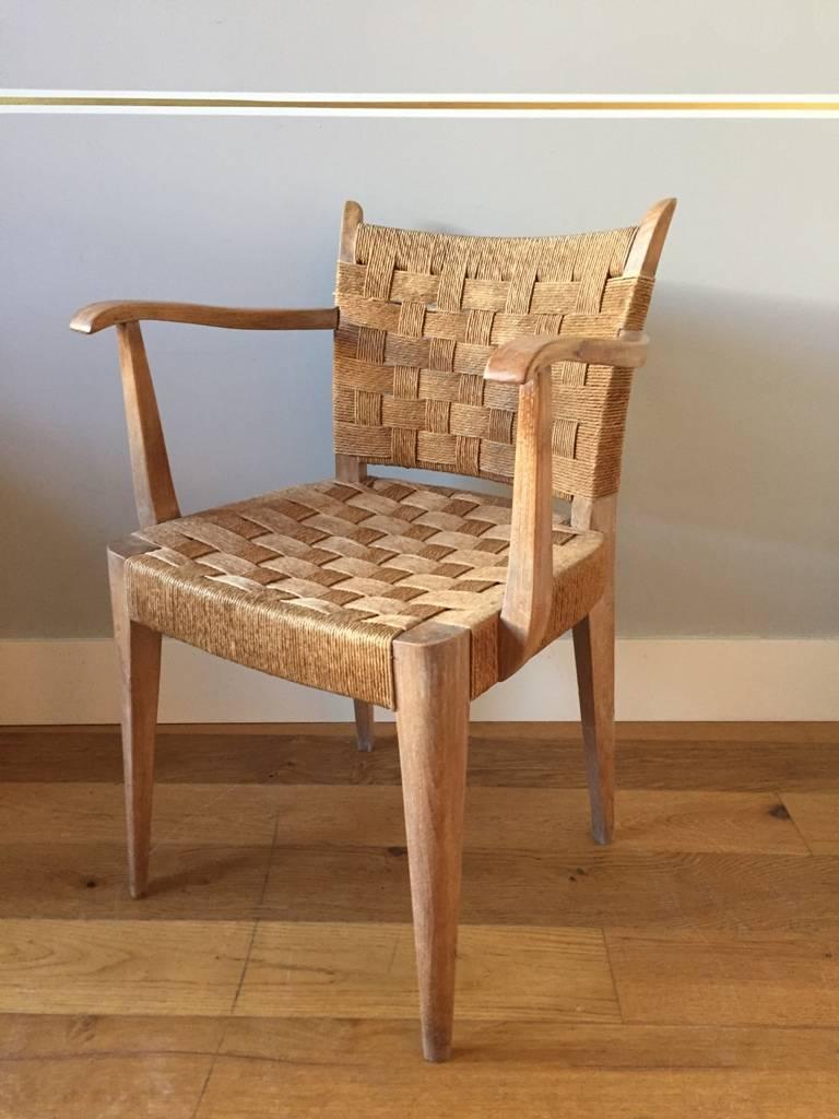 A pair of limed beech a woven seagrass cord armchairs, 
France, circa 1935
(two pairs available, totaling four armchairs).