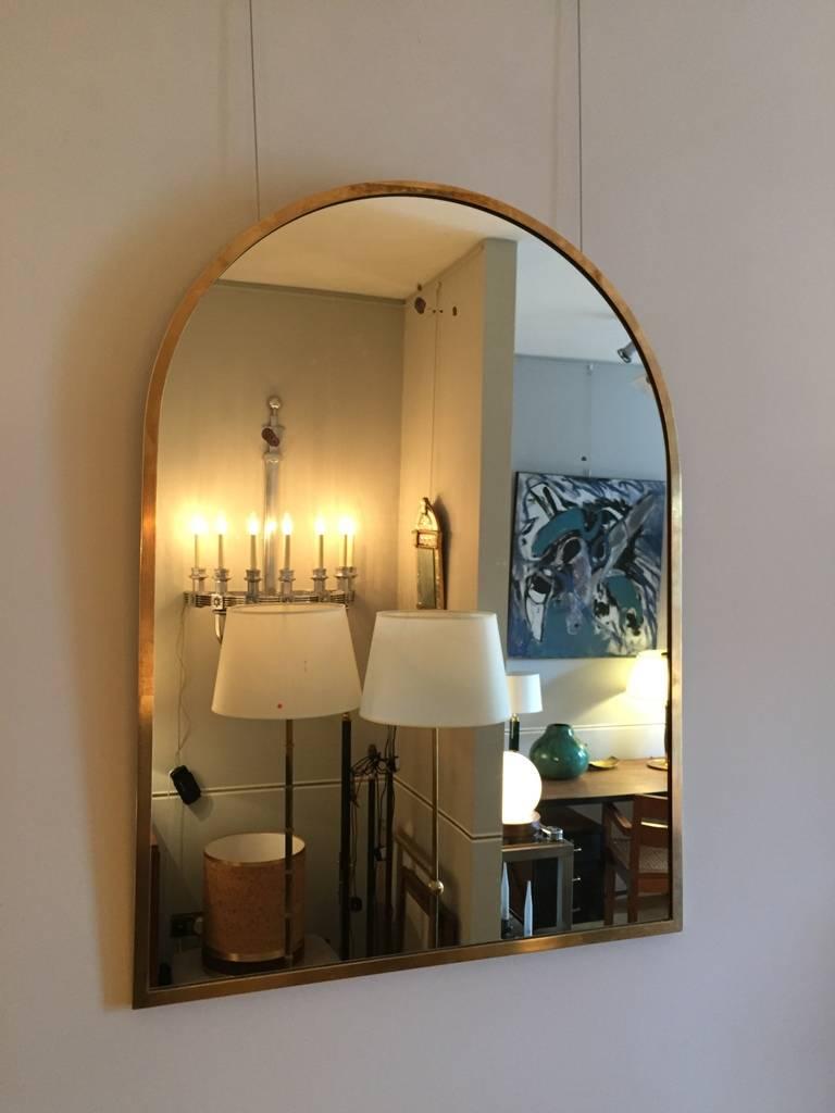 A good sized brass arch top mirror, with its original mirror plate.
Italy, circa 1950.