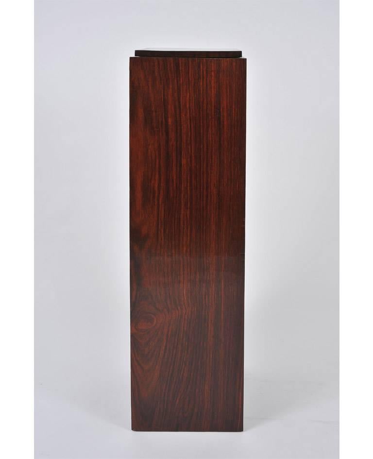 An Art Deco rosewood veneered square pedestal, with a stepped removable top
France, circa 1930.