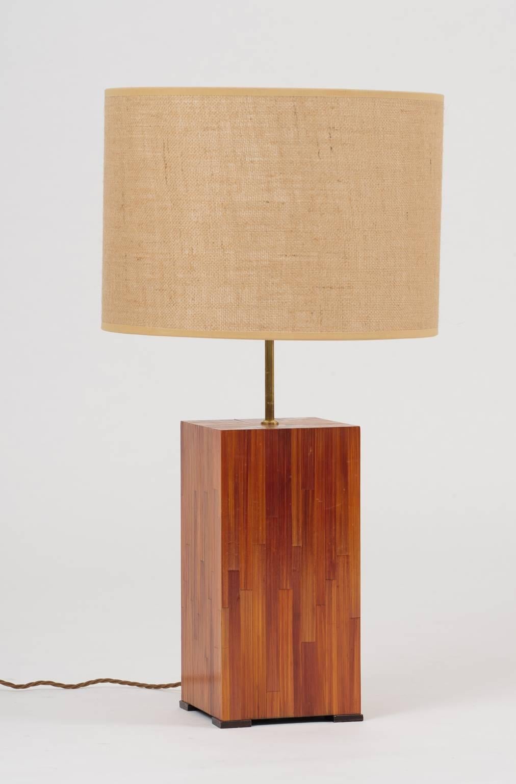 A straw marquetry square lamp, on darker straw square feet, the bras stem supporting a bespoke hessian drum shade
France, third quarter of the 20th century.