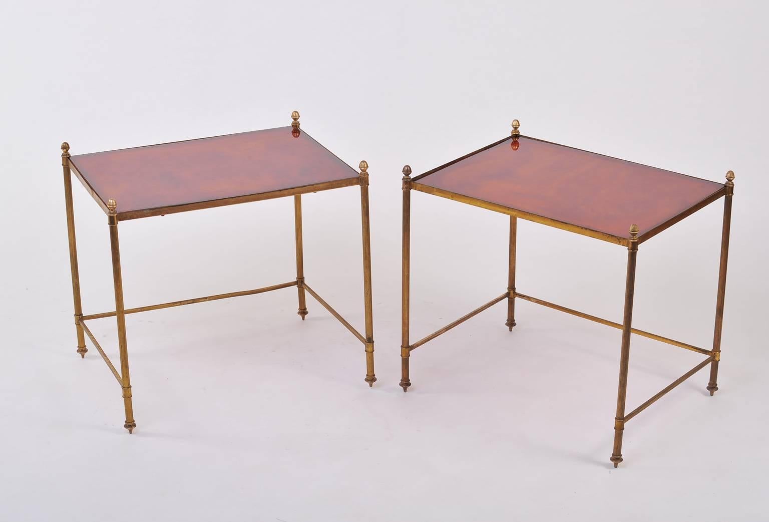 A pair of gilt brass and faux tortoiseshell tops side tables, on toupie feet and topped with acorn finials
Possibly by Maison Baguès,
France, circa 1950.