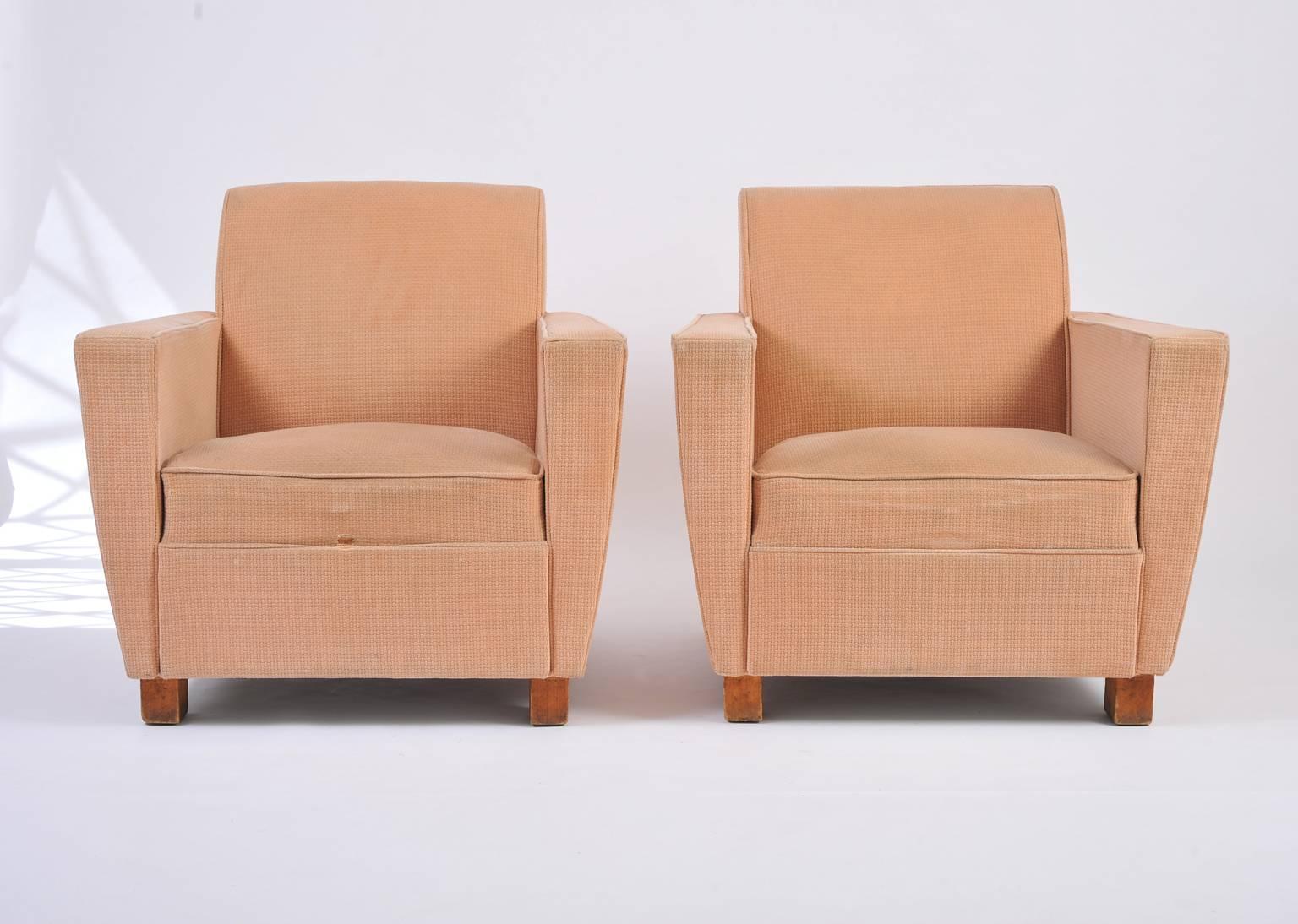 A pair of large club armchairs, of geometric modernist shape, in the manner of Jacques Adnet (1900-1984), in their original patterned velvet upholstery.
France, circa 1940.