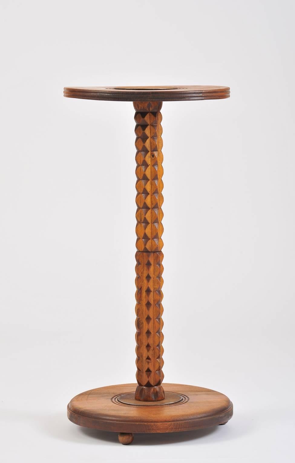 A most curious stained oak tall side table or pedestal, in the manner of Guillerme et Chambron, the base and top with dark patinated iron pastilles, on three solid ball feet.
France, third quarter of the 20th century.