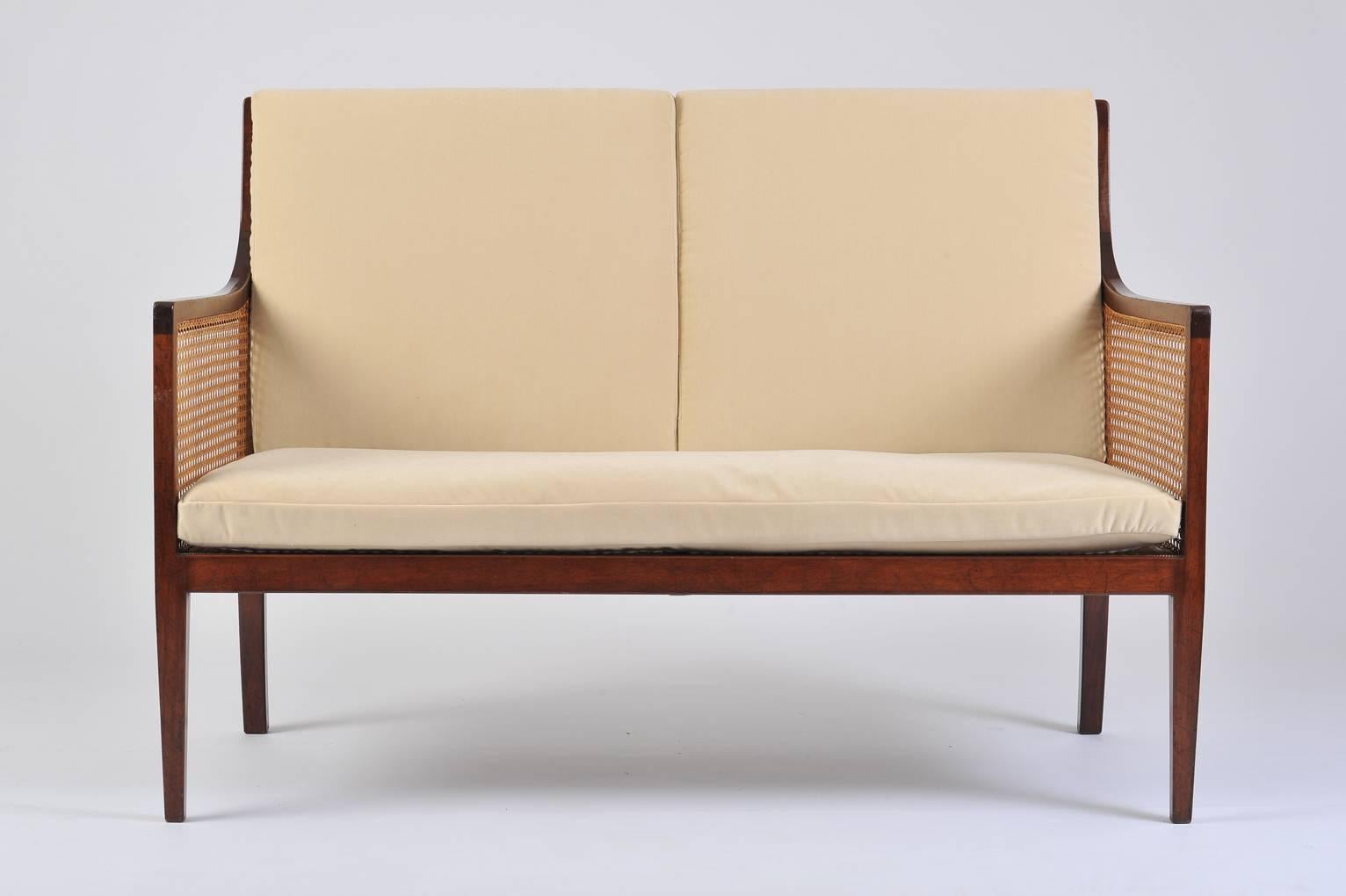 A cane and mahogany two-seat sofa
Sweden, circa 1920.