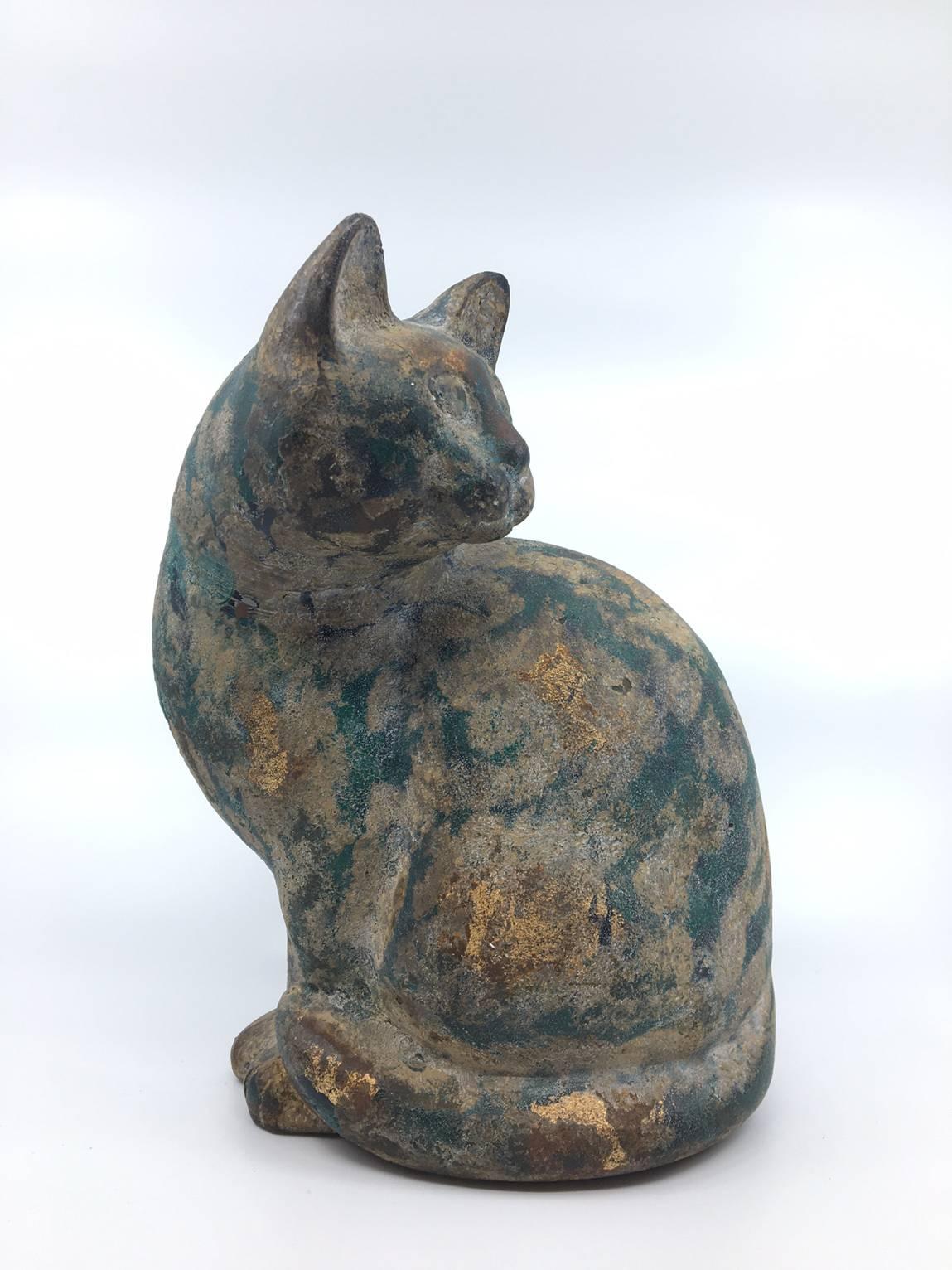 A cast iron, parcel-gilt and green patinated figure of a cat
France, circa 1930.