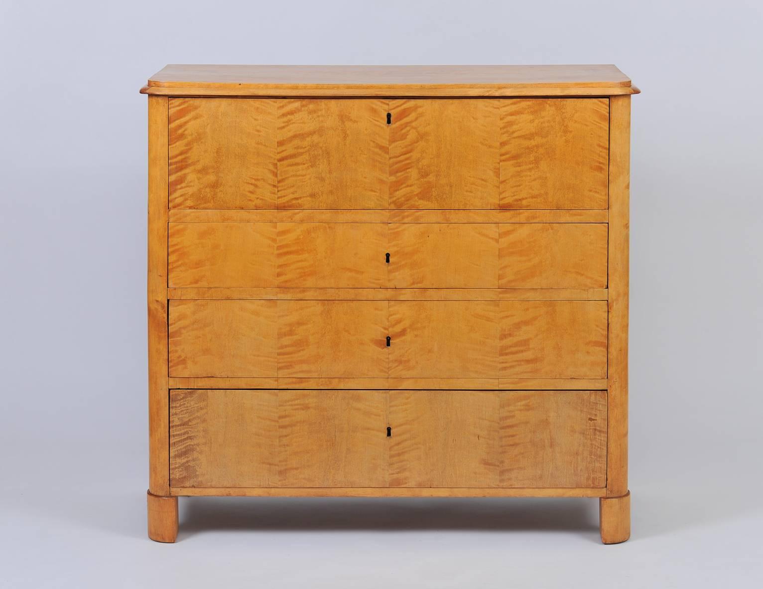 A Biedermeier birch veneered chest of drawers, the top drawer revealing a secretaire, fully fitted with 14 drawers adorned with bone knobs
Sweden, circa 1840.