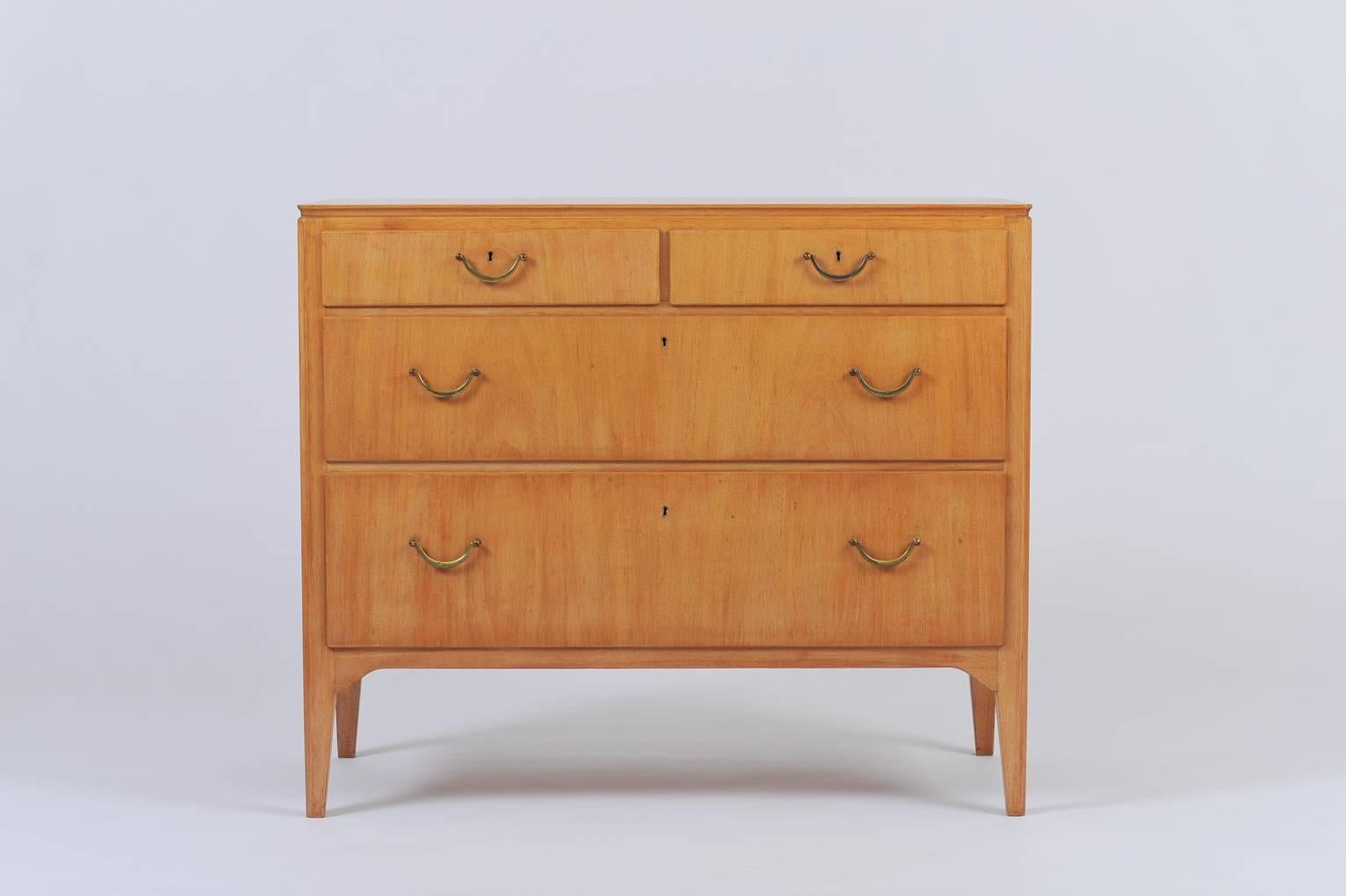 A four-drawer chest by David Rosén for Nordiska Kompaniet of Stockholm, Sweden.
Each drawer with a brass handle and brass key hole.
Bearing the original maker's stamped brass label with inventory number and dated 1946.
Key in working order
