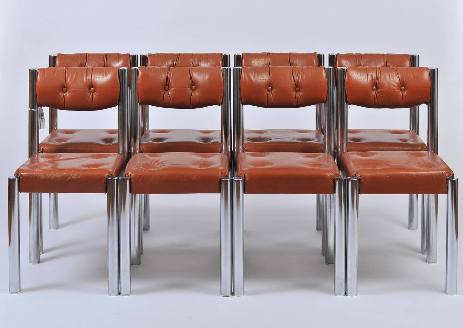 A set of eight chrome and brown leather dining chairs, the polished chrome frames supporting very comfortable padded buttoned seats and backs,
France, circa 1970.