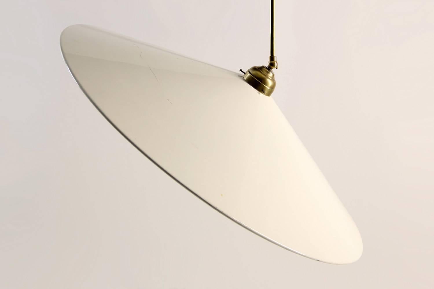 Beautiful Italian 1950s pendant lamp in the style of Stilnovo with opal white enamelled lampshade and a brass structure with two individually adjustable joints. The lamp is extendable from 70 cm to 100 cm and in a very good vintage condition with