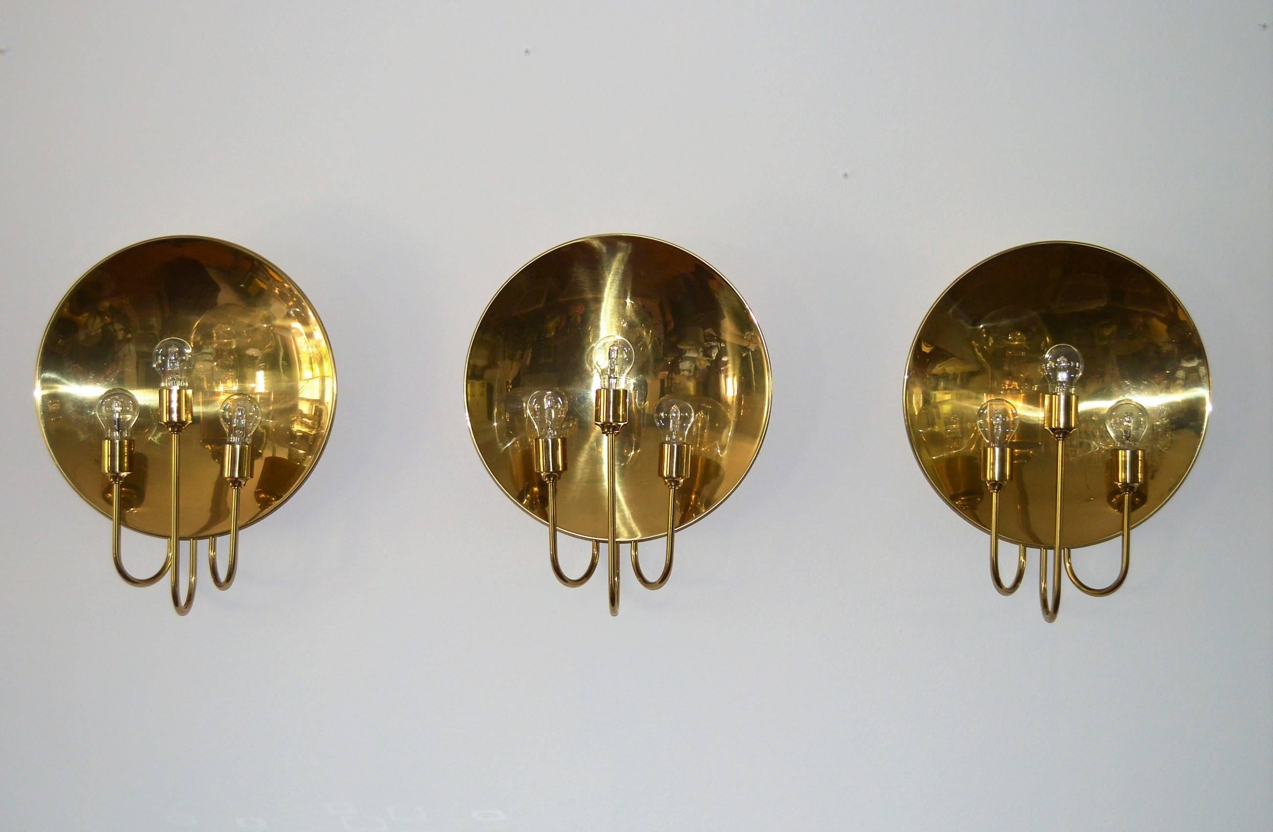 A stunning and very rare set of three huge and gorgeous wall sconces in full polished brass, made from German Florian Schulz in the 1970s.
Every wall light has three arms for three Edison bulbs.
The sconces are in excellent shiny condition without