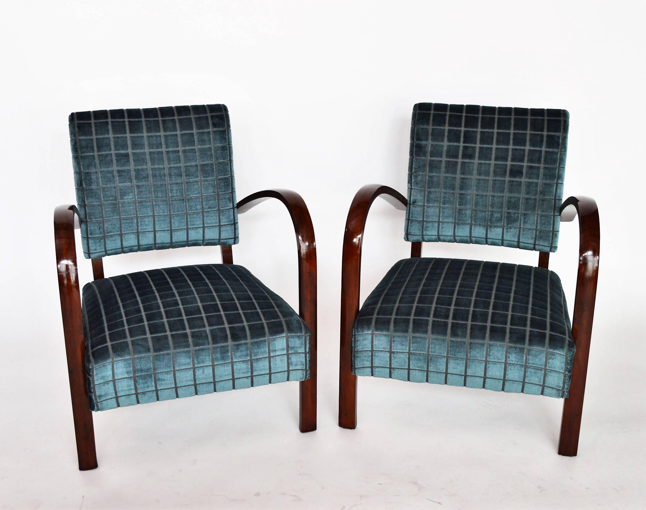 Beautiful pair of two low armchairs with curved armrests in beech wood.
Made in Italy in the 1940s.
The beech wood have been walnut stained to become darker, both chairs have been completely restored and re-upholstered with elegant and soft velvet