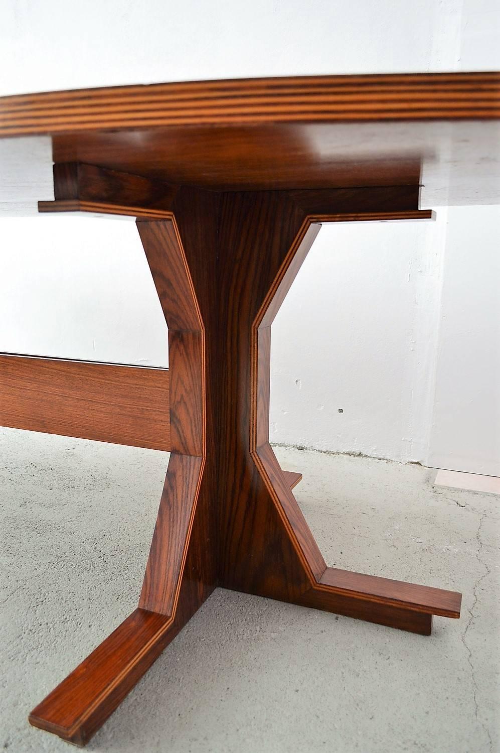 Hugh wooden table with beautiful and particular details in the style of Gianfranco Frattini.
Excellent craftsmanship in very good original condition with small signs of wear, please have a look to all pictures. More pictures are available.
Could be