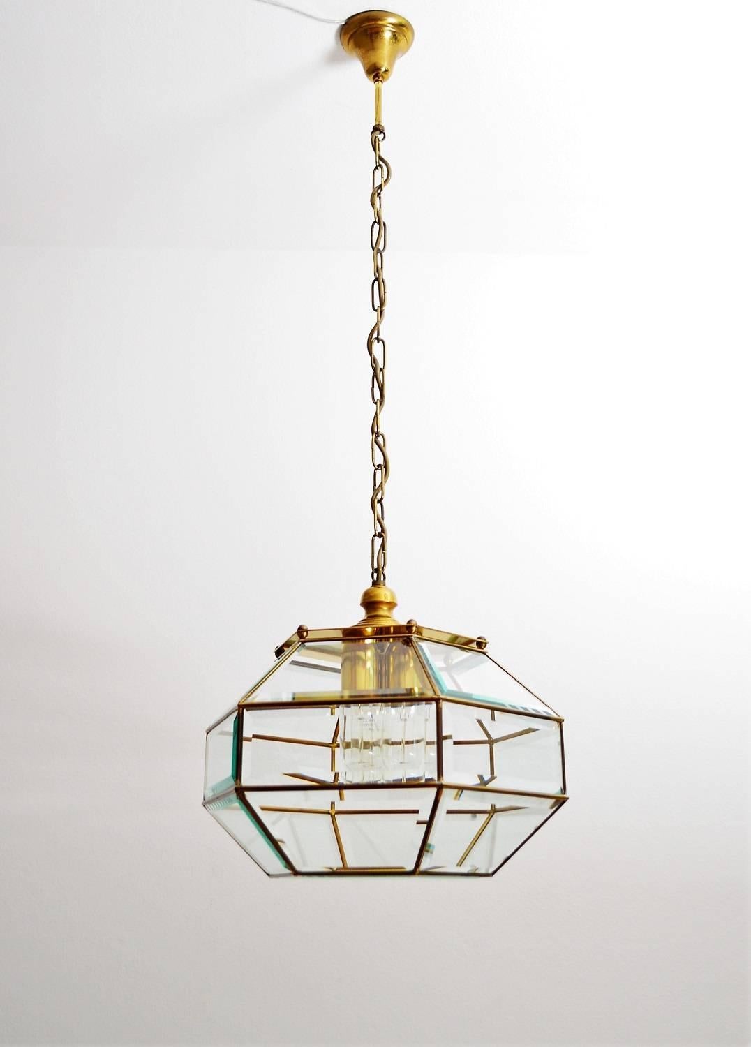 Beautiful ceiling pendant or glass lantern from the Italian, 1960s.
Made of shiny cut crystal glass and brass frame as well as brass details with dark patina.
The lamp works with three big light bulbs.
The height of only lantern (without chain)