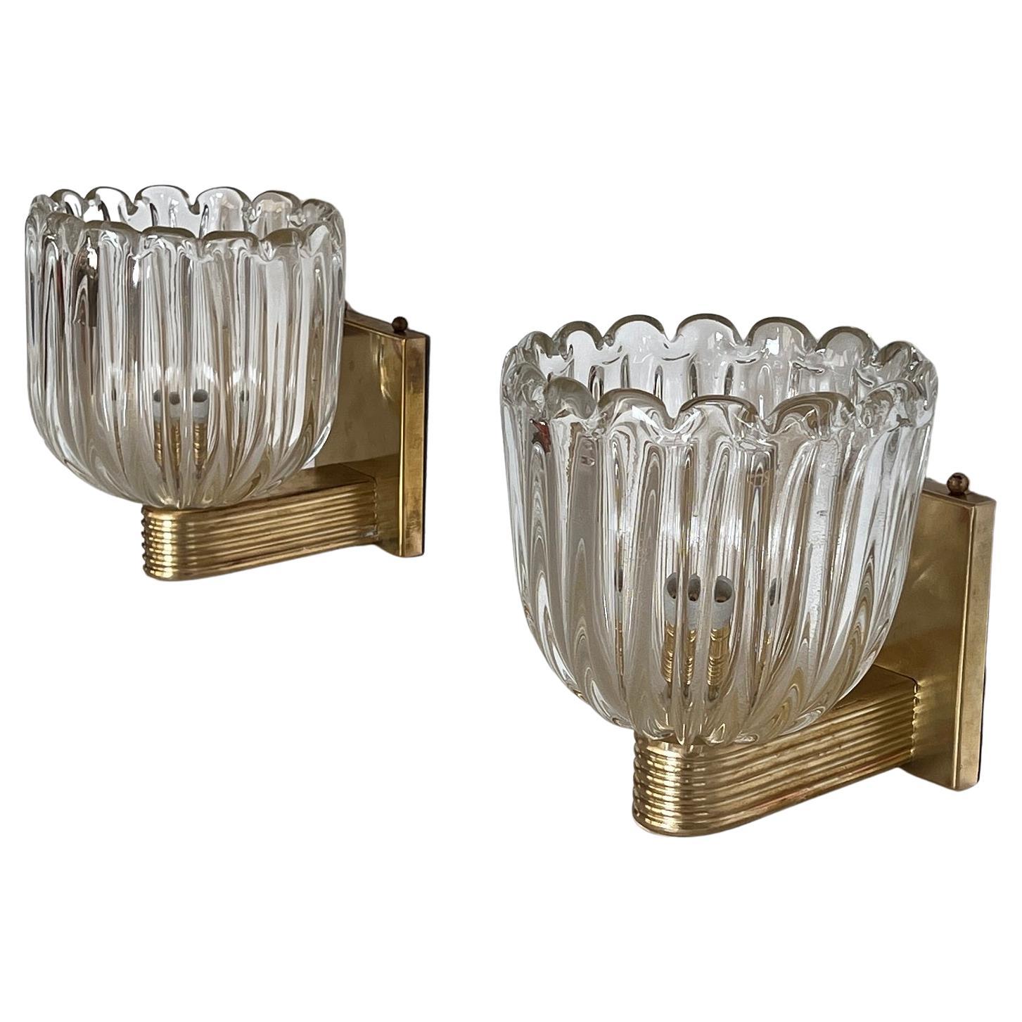 Beautiful set of two gorgeous brass wall lamps made of strong brass base and light amber-transparent Murano glasses with golden shimmer/glitter inside the glass. Art Deco style.
Made in Murano, Venice, Italy.
The brass is partially with little