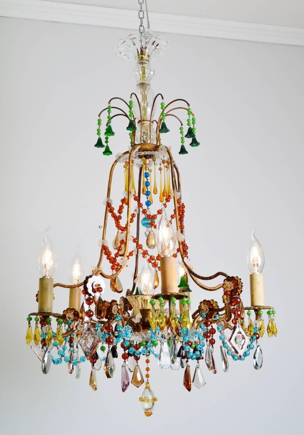 Beautiful and unique multicolored crystal glass chandelier, very rare and one-of-a-kind.
This chandelier has a typical French gilt "cage form", with five arms for five small candelabra bulbs as well as another small bulb in the middle of
