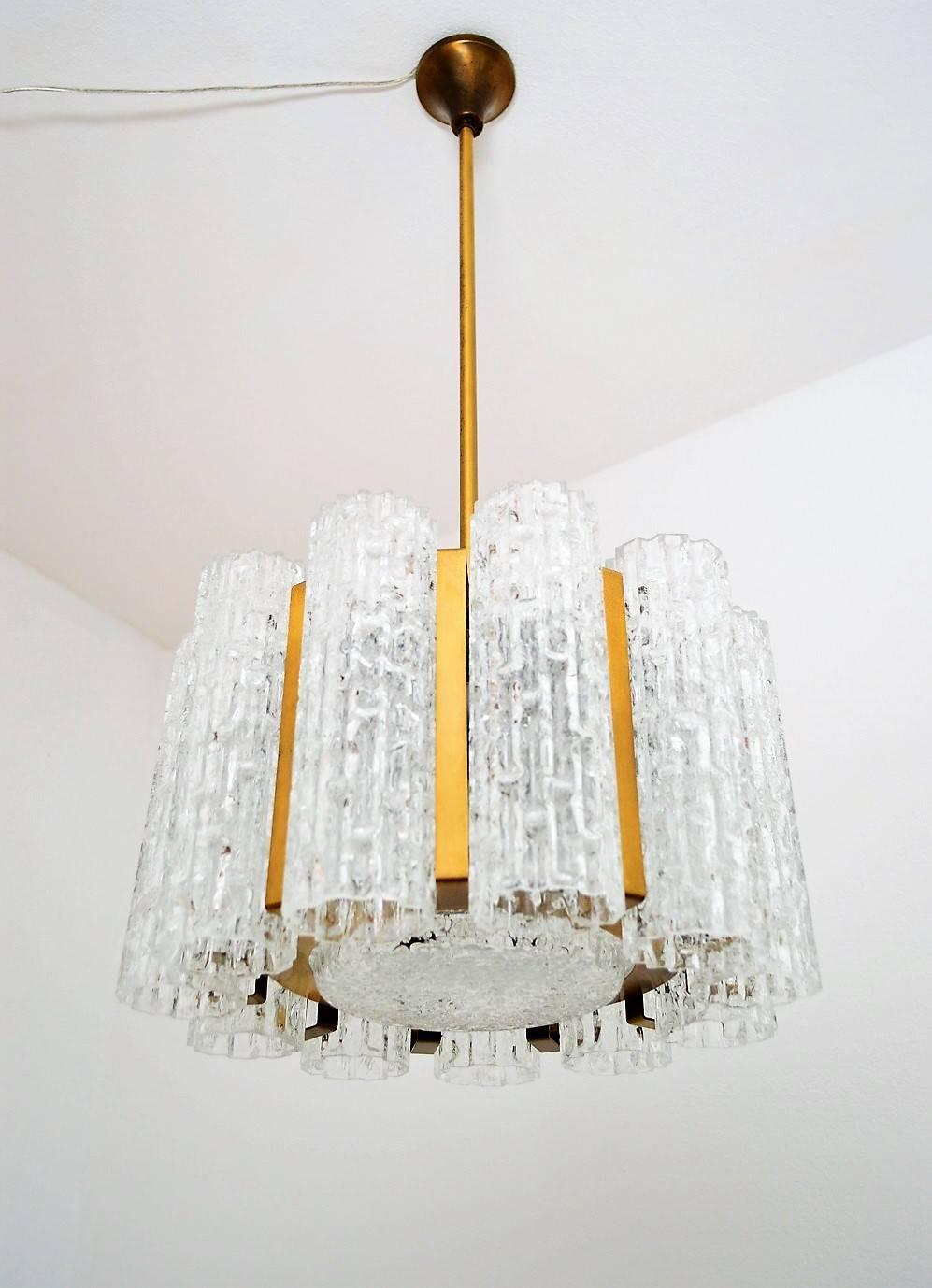 Charming and heavy quality chandelier with 11 ice glass tubes, 1 big ice glass plate and a lamp frame made of brass with beautiful patina.
Equipped for five-light bulbs
Excellent overall condition.
     