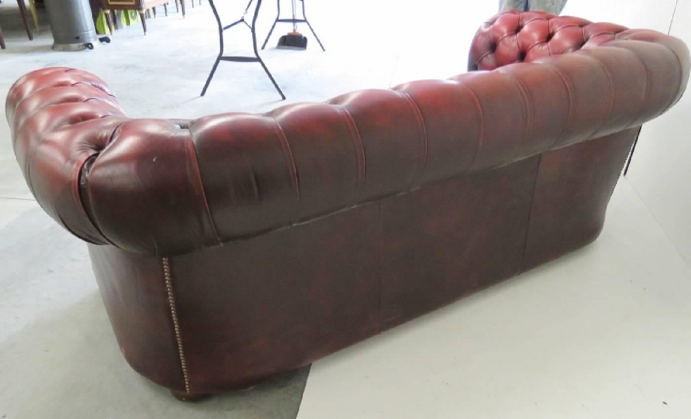 red leather tufted sofa
