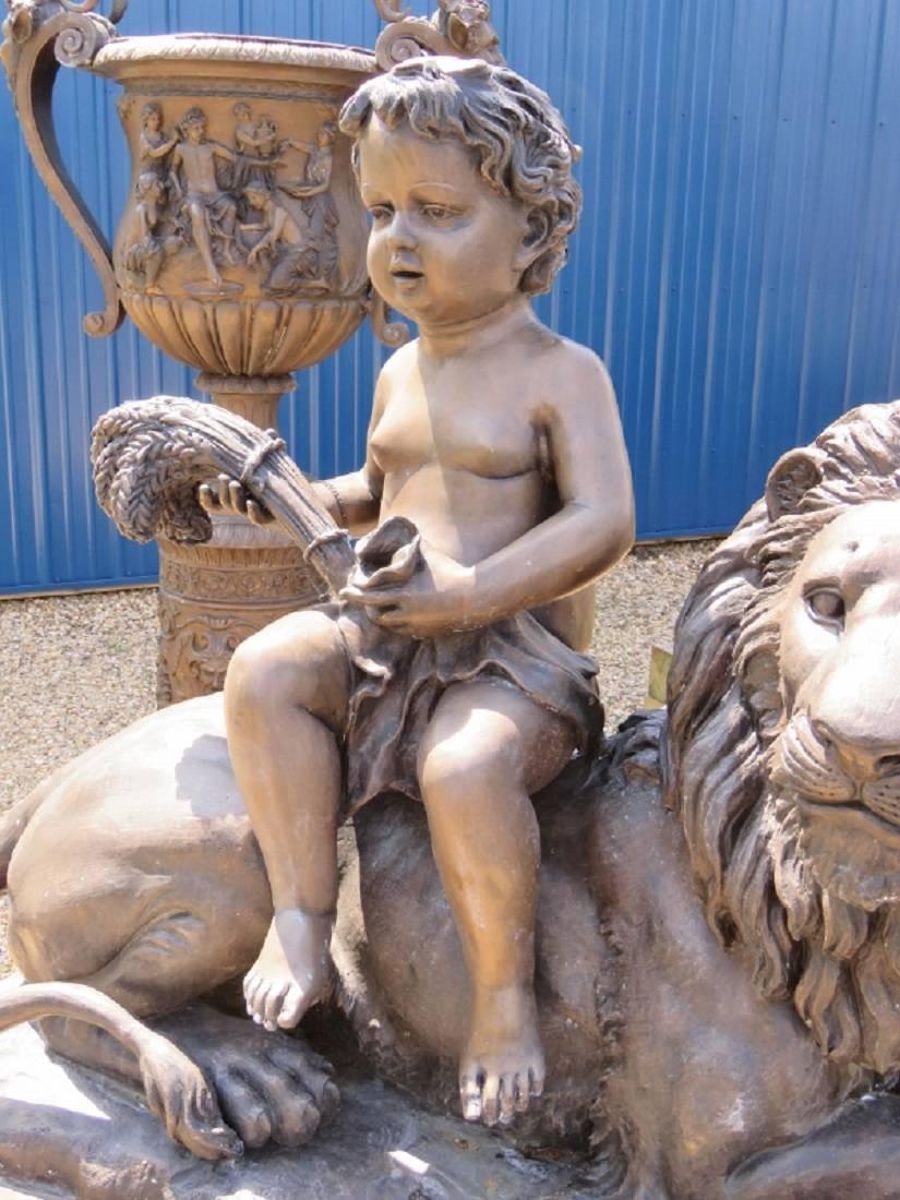 Statue marked Steven Bennett. Statue is of a boy sitting on a lion with allegorical scenes on the base.