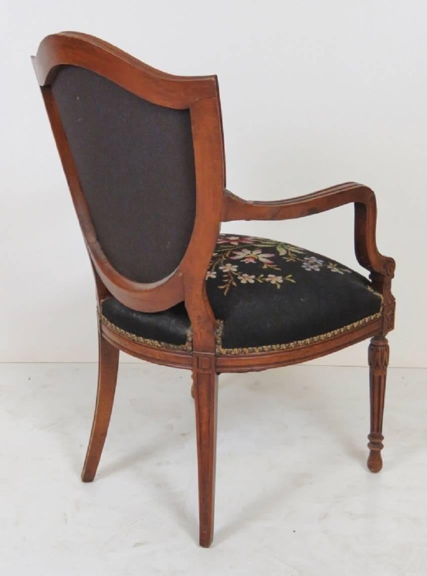 Fauteuil has a finely carved frame with needlepoint.